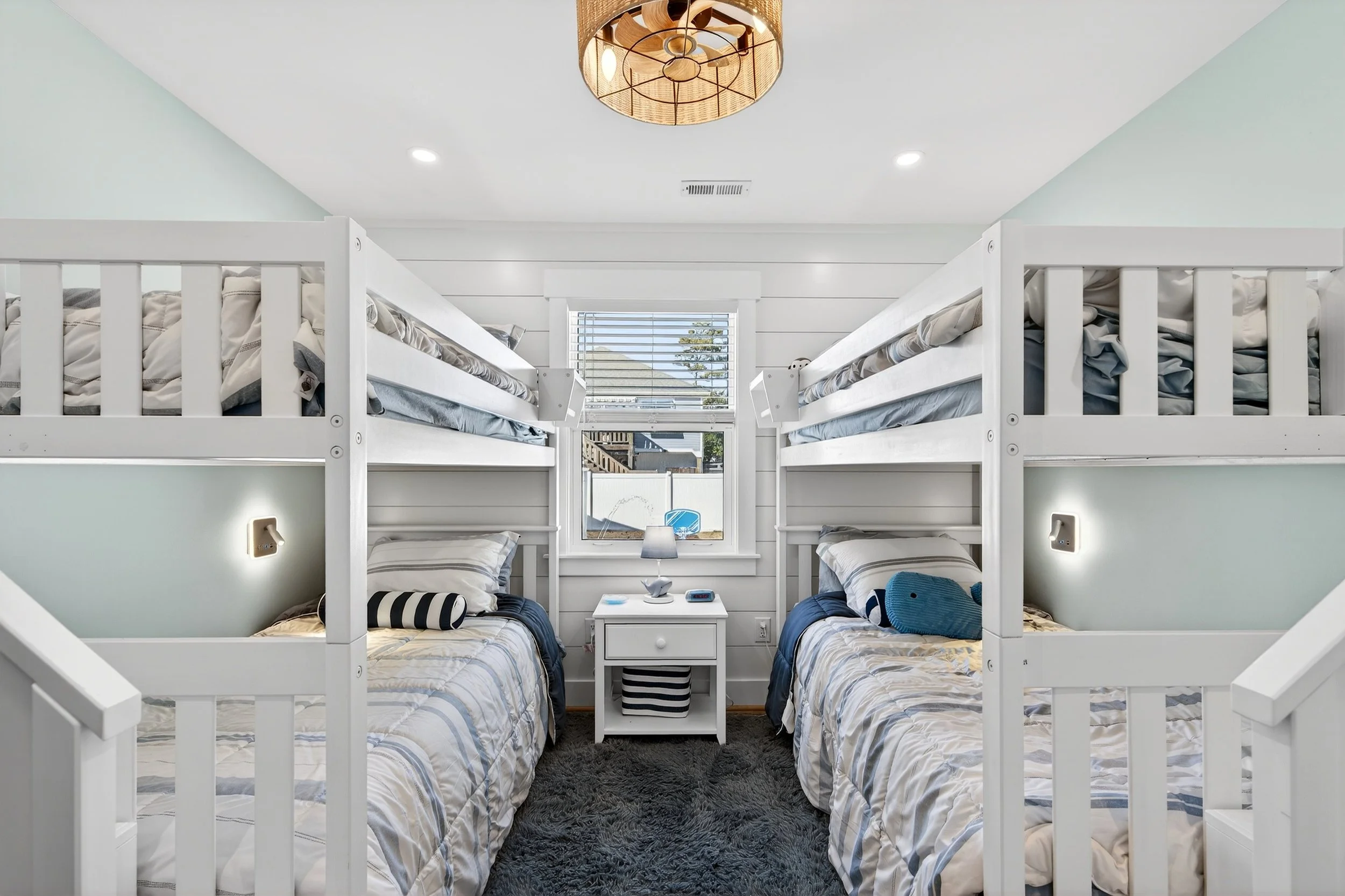 Bunk bedroom interior in Oak Island beach home photographed for real estate listing.