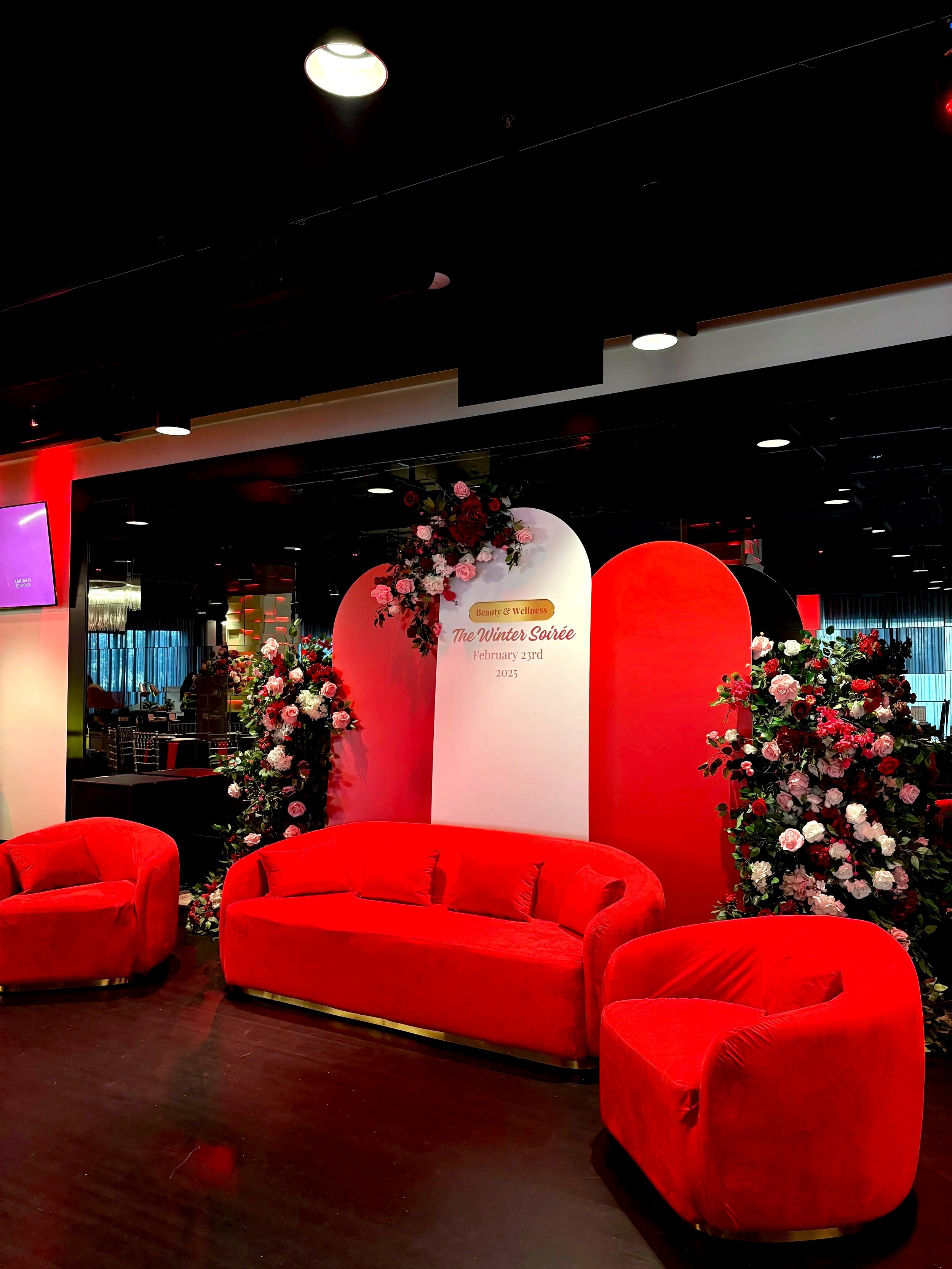 Outdoor dining setup with a long table, chairs, and string lights in a natural garden setting.