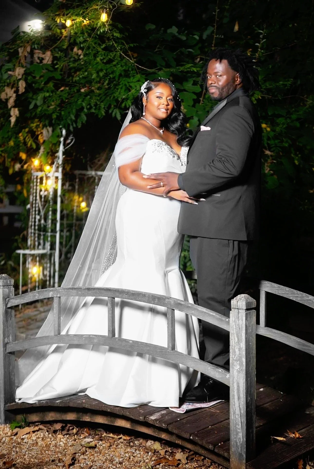 Ebony’s customers, Lauren and Daryl embracing by the bridge on their wedding day.