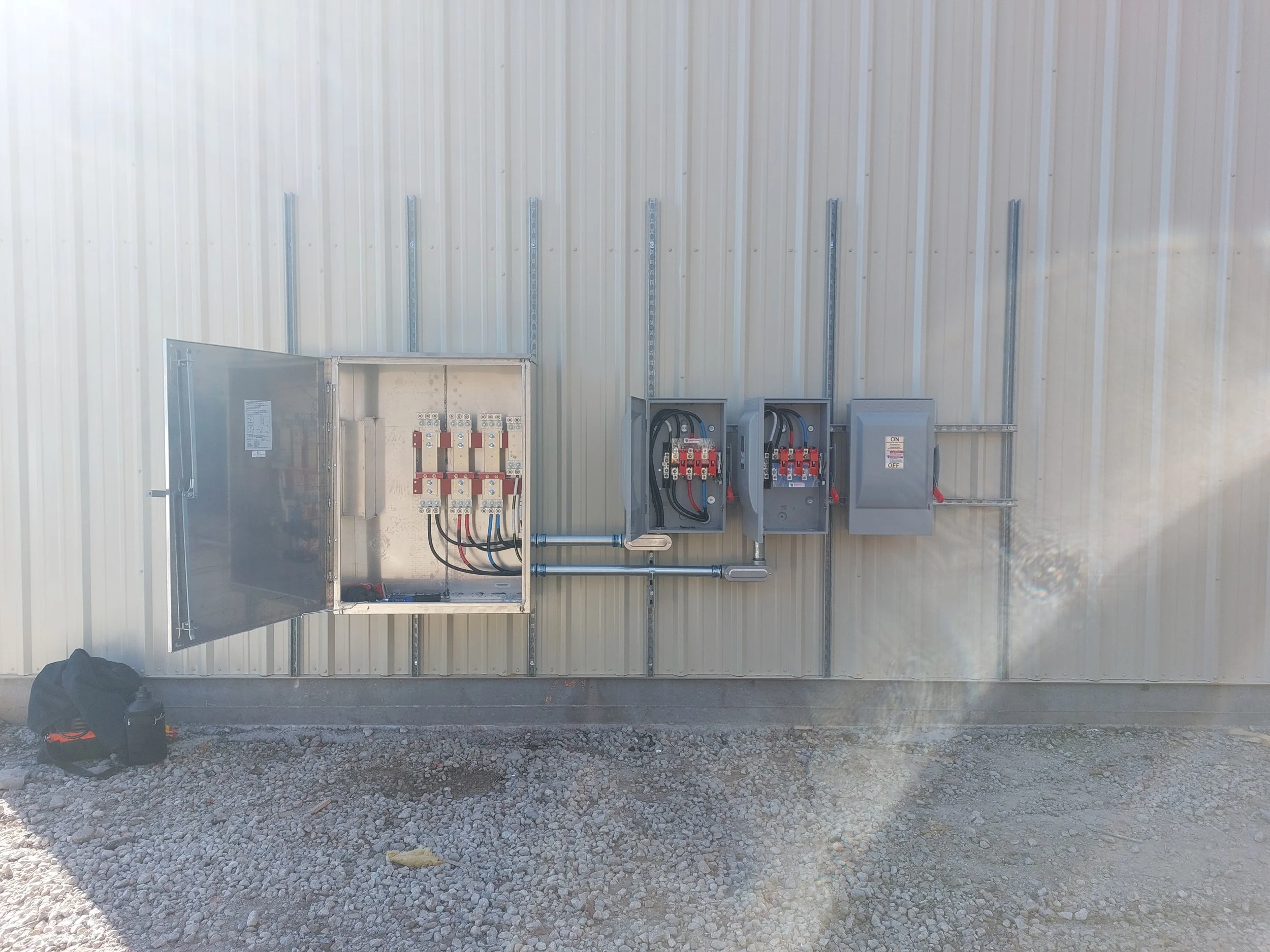 Electrical distribution panel and CT cabinet on exterior wall of a building.