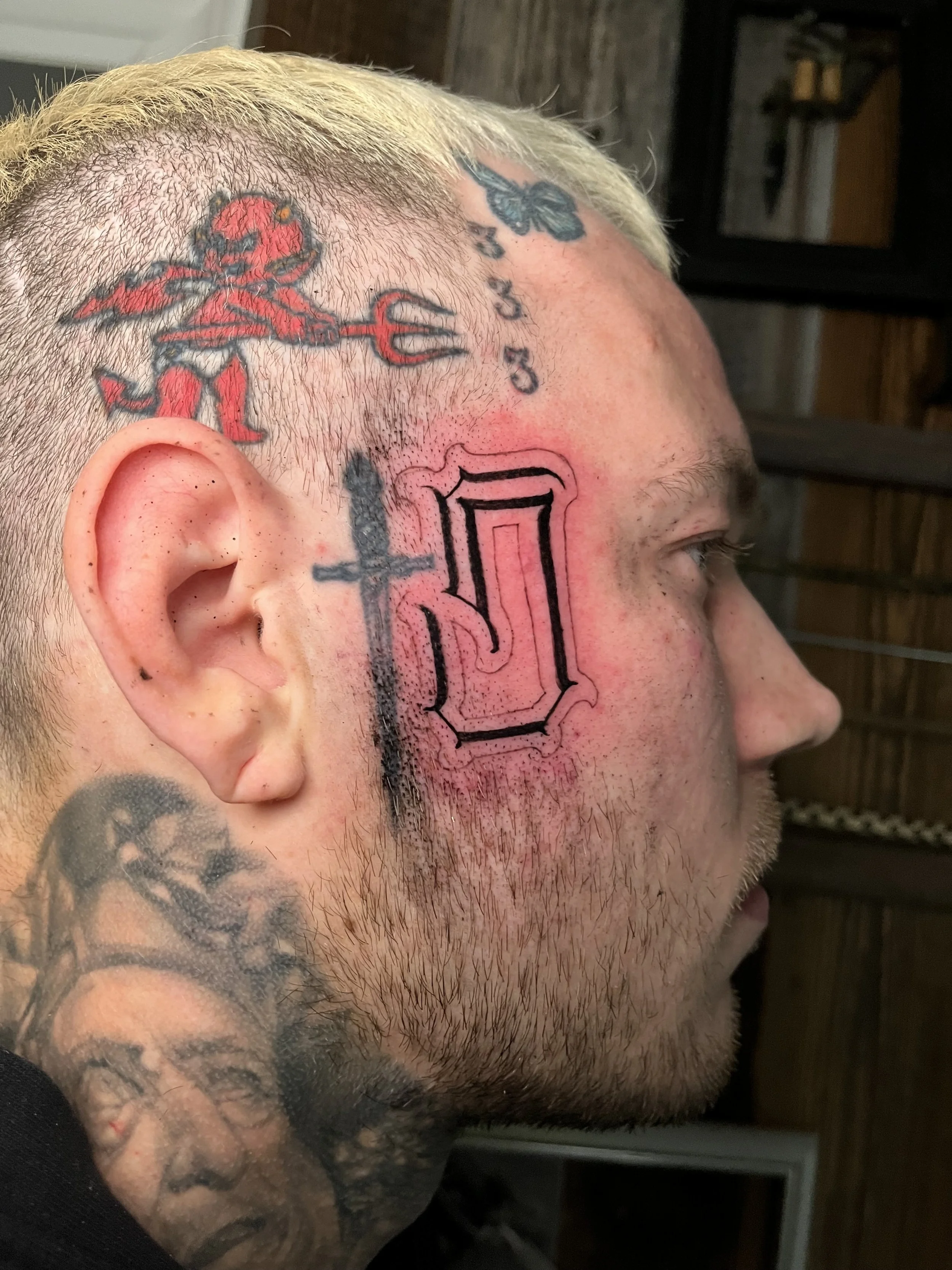 Chicano Lettering Black and Grey Letter S Face Tattoo Done By LonoTattoo