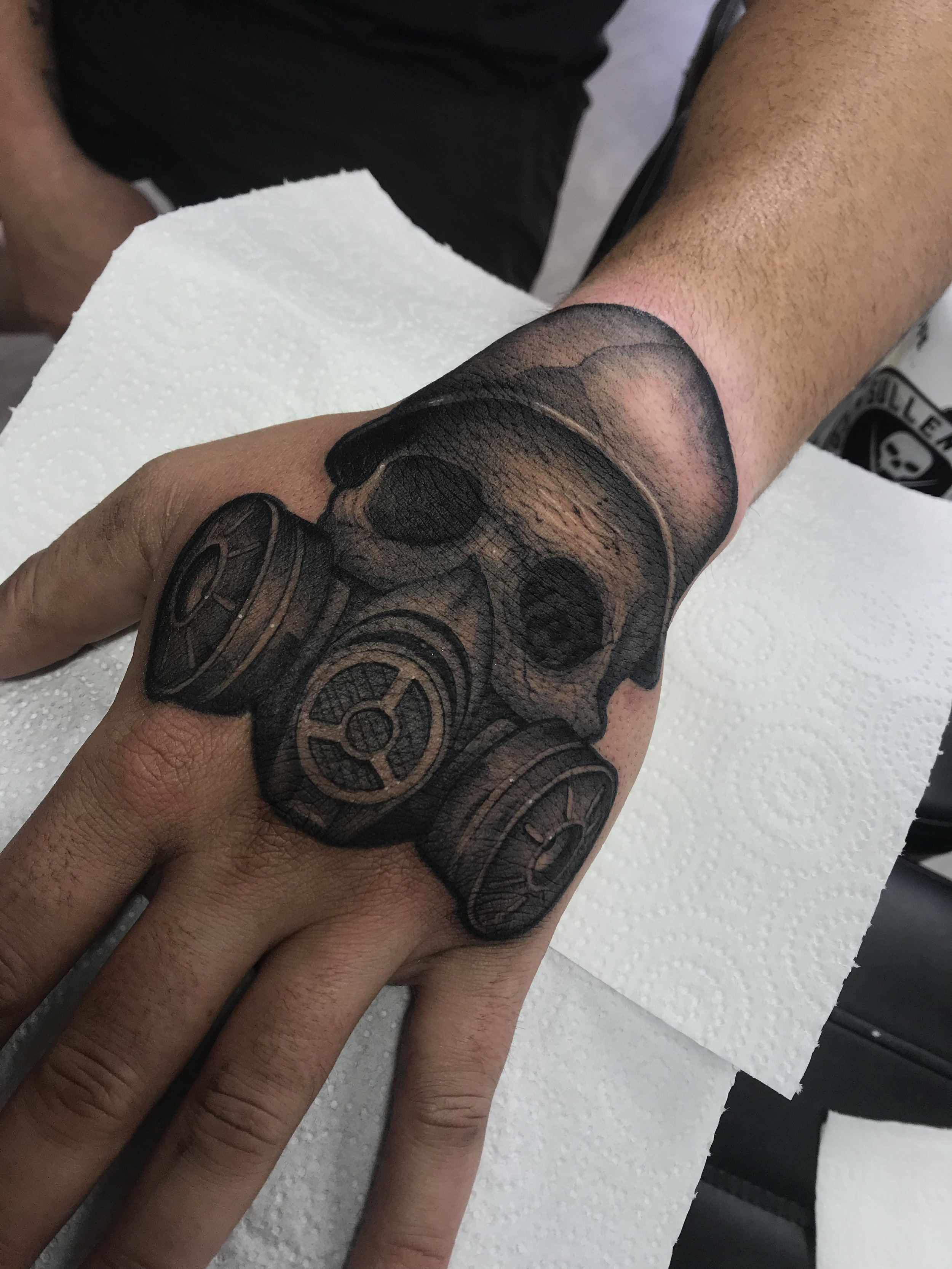 Traditional Toxic Masked Skull Black and Grey Hand Tattoo Done By LonoTattoo