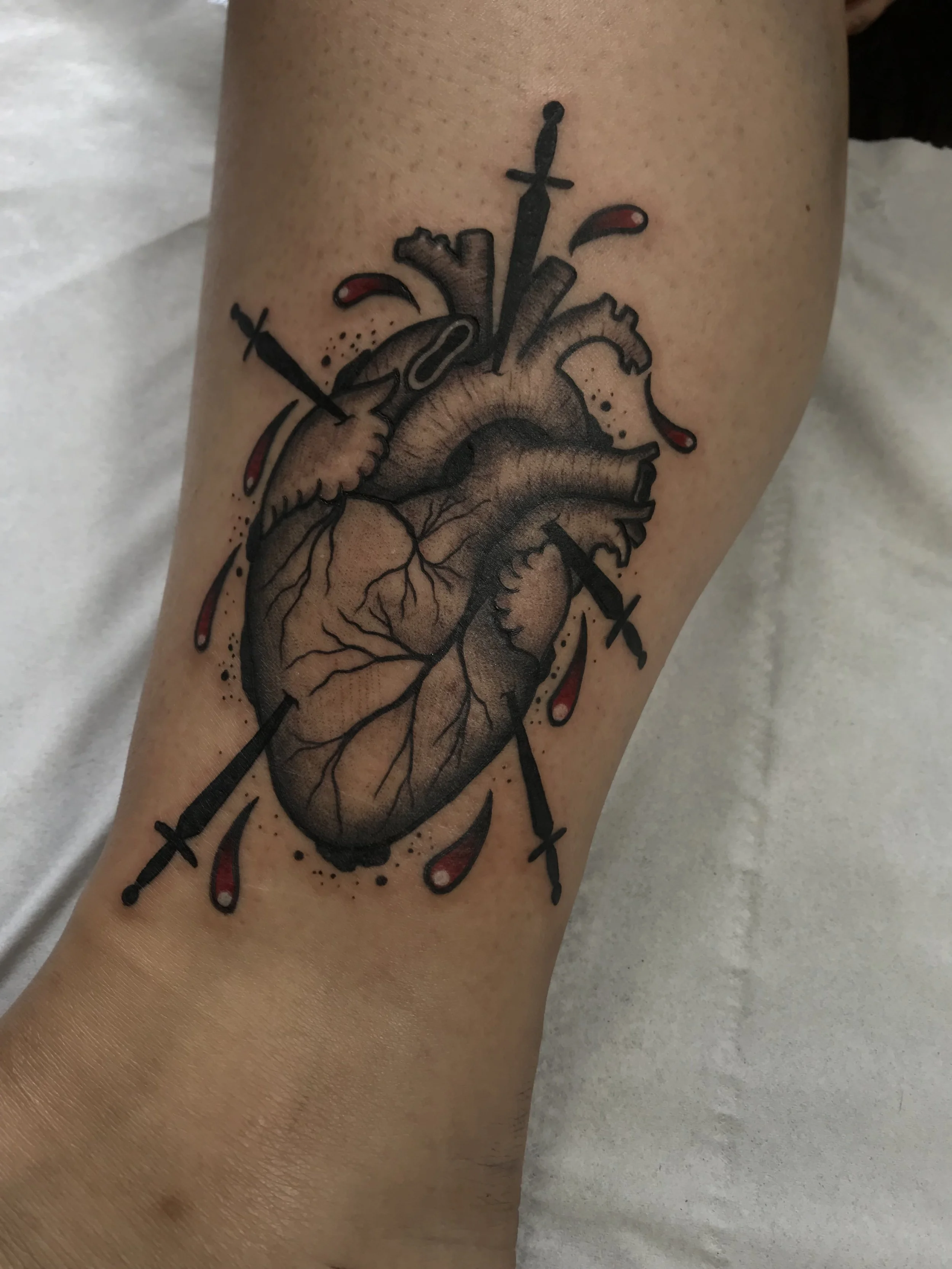 Traditional Anatomical Heart Black and Grey and Red Leg Tattoo Done By LonoTattoo