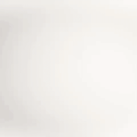 Close-up of a white surface with small, faint colored dots.