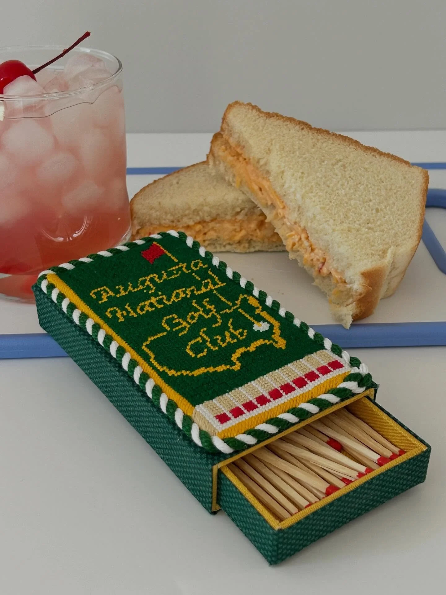 Pimento cheese, an Azalea, and a matchbox pretending it&rsquo;s on the Champions Dinner menu.

#AugustaNational #MastersWeek
#PimentoCheese
#AzaleaDrink
 #AmenCorner