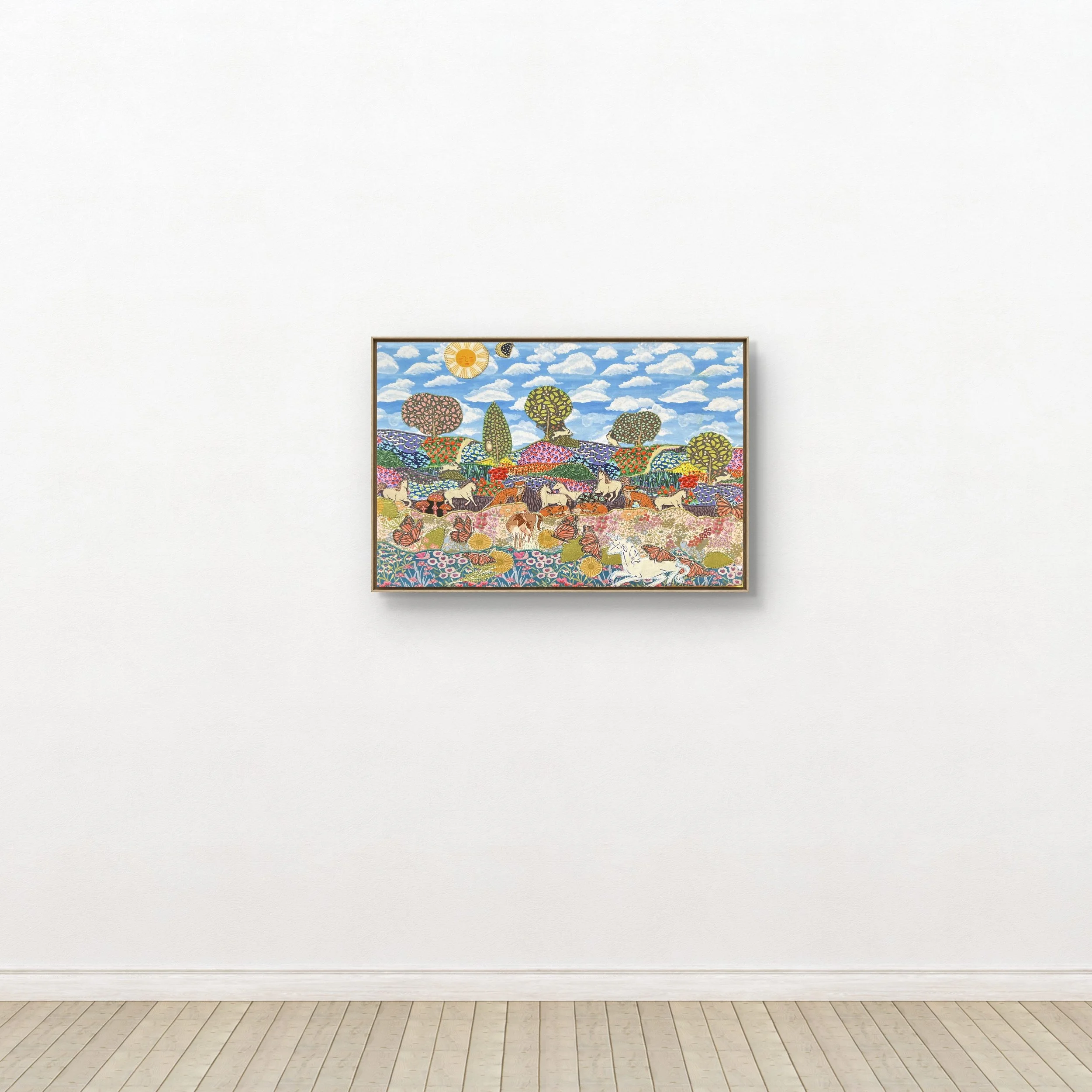 Colorful landscape textile collage featuring trees, animals, and a bright sky with clouds, hung on a white gallery wall.