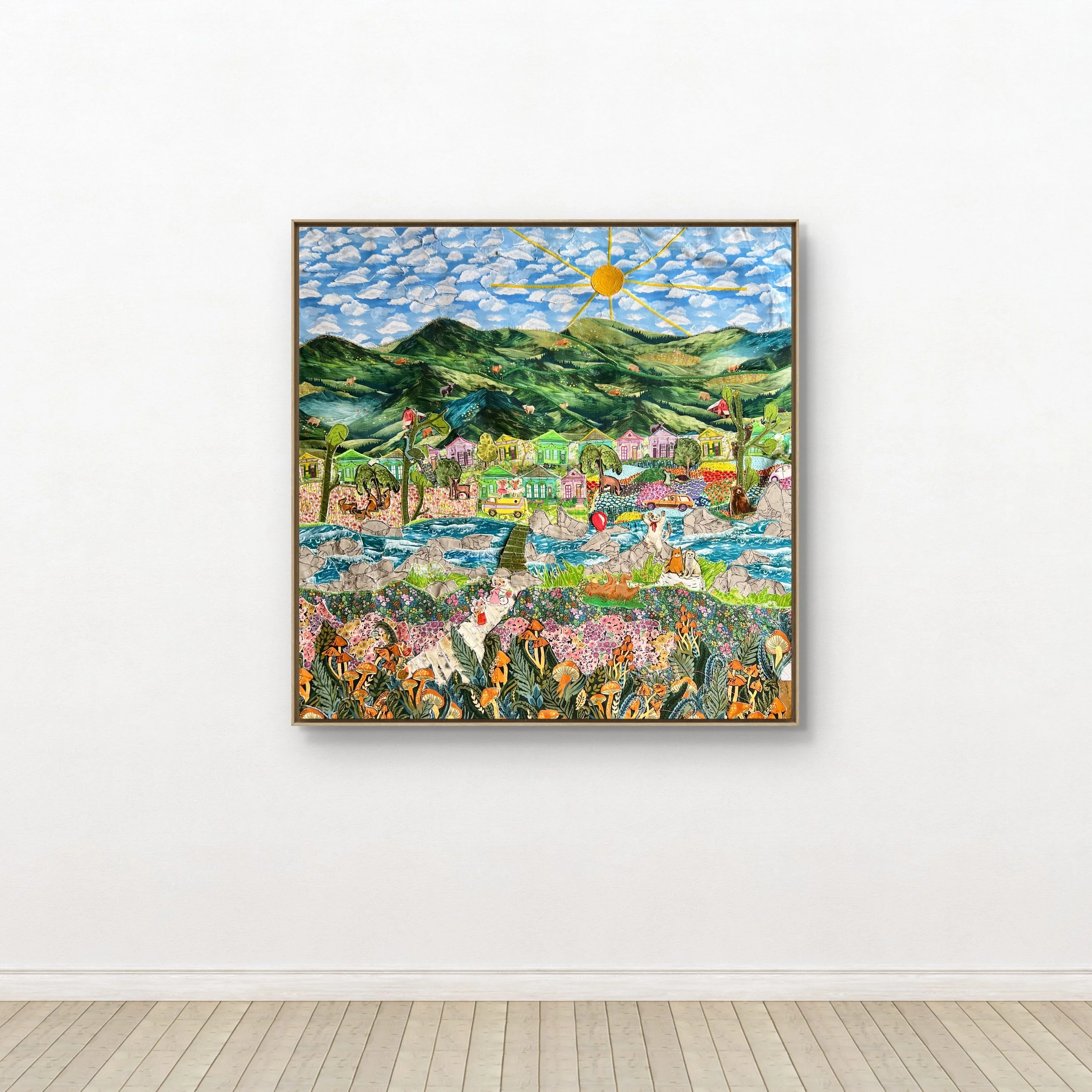 Colorful textile collage depicting green hills, a river, a small village, and a bright sun in the sky.