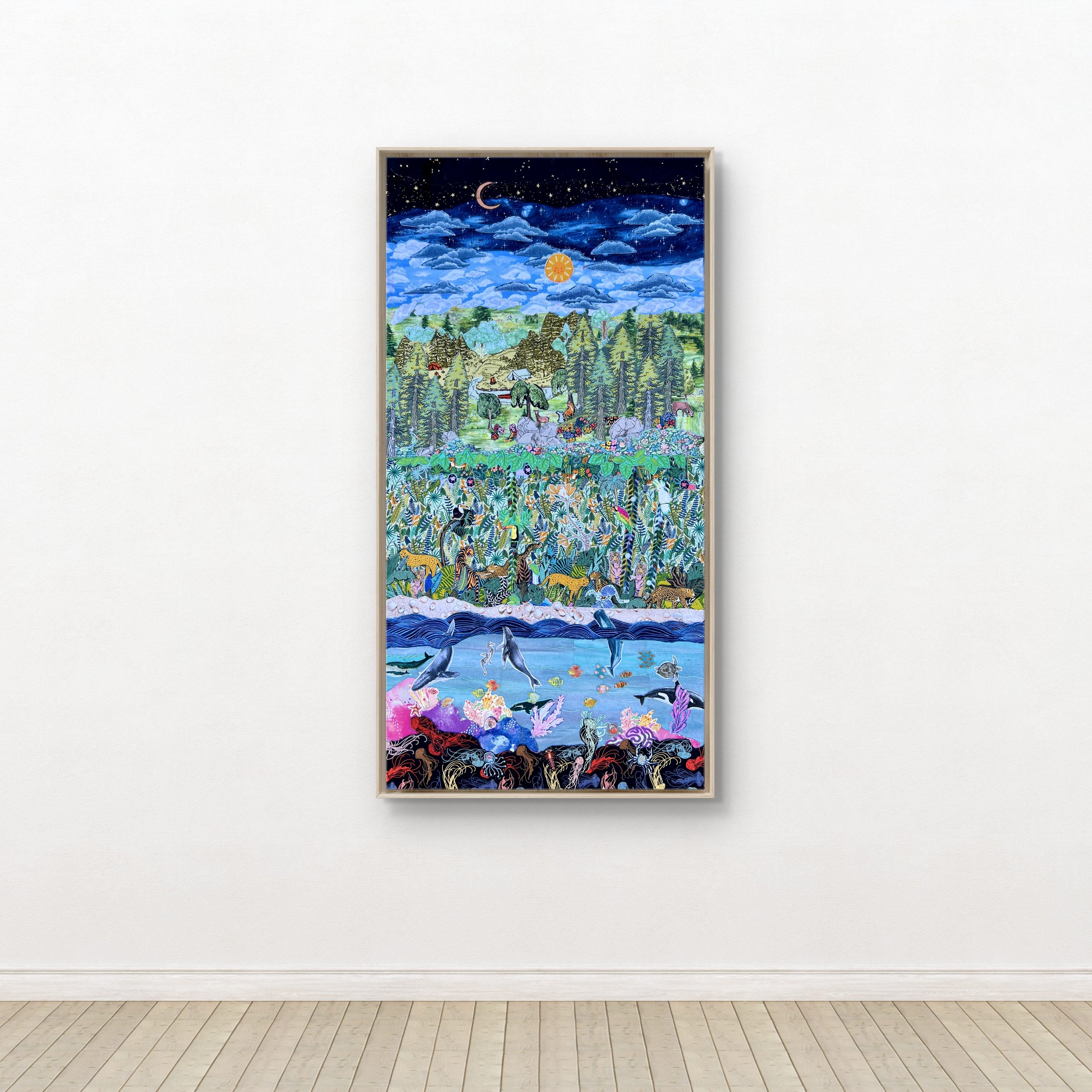 Colorful textile collage depicting a landscape with animals, trees, water, and a night sky with stars, moon, sun, and clouds.