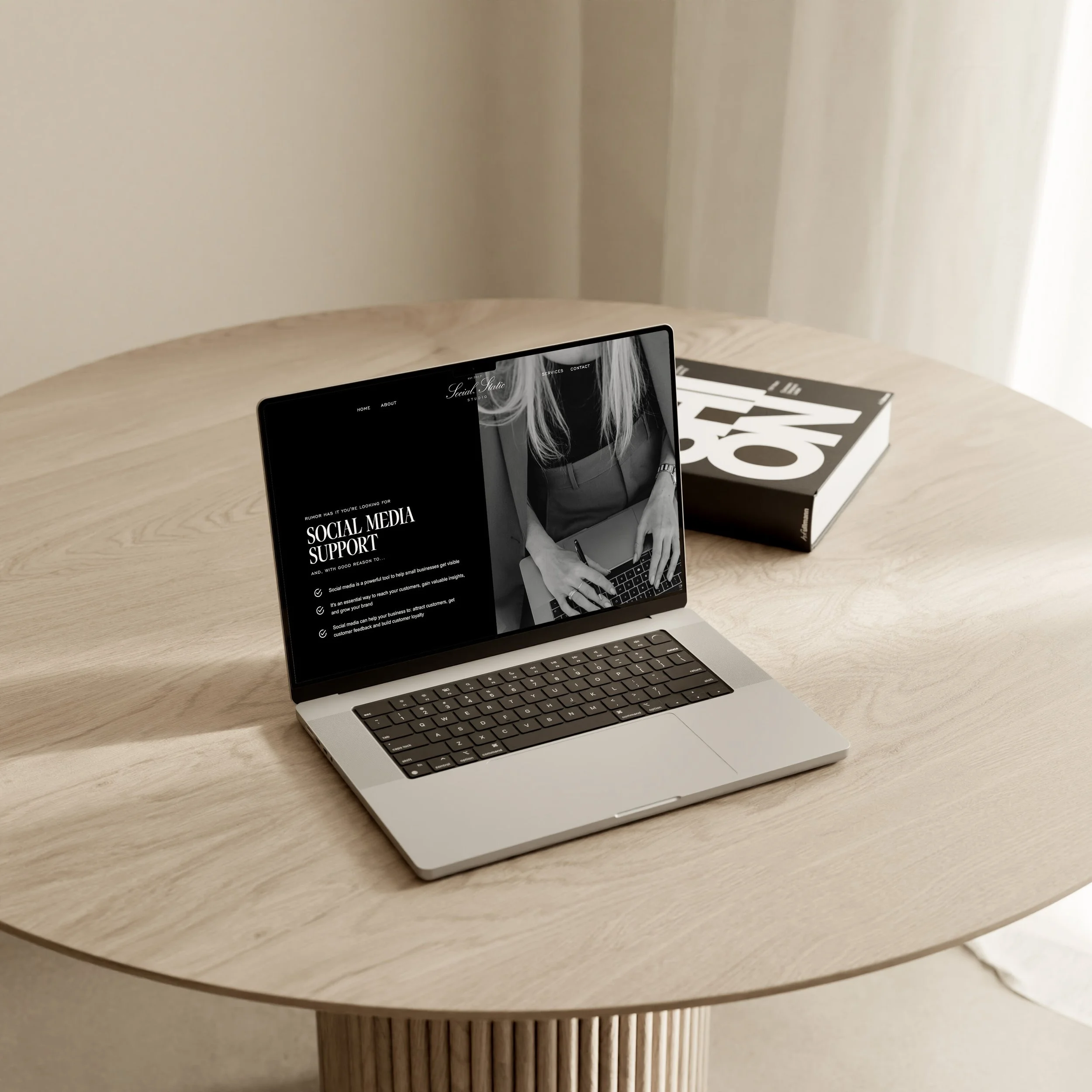 A laptop displaying a social media website on a wooden table.
