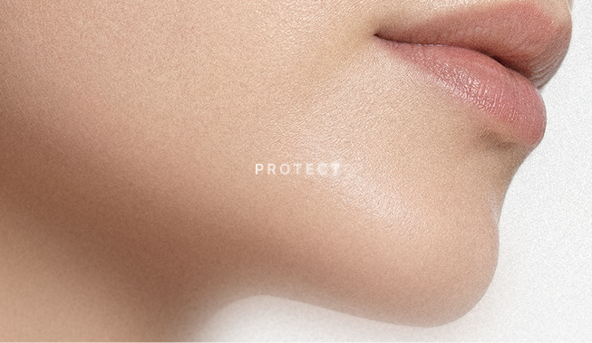 Close-up of a person's lower face and lips with a small white text on the cheek that says 'PROTECT'.