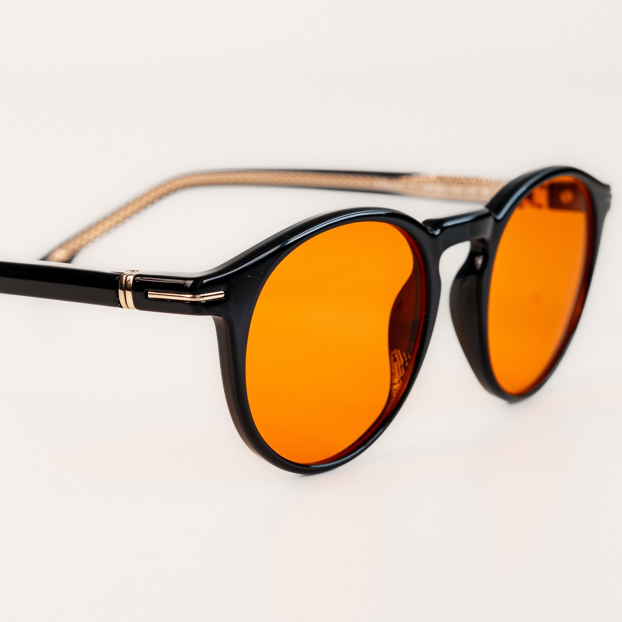 Durham blue light glasses close up side view black acetate round frame with amber orange lenses