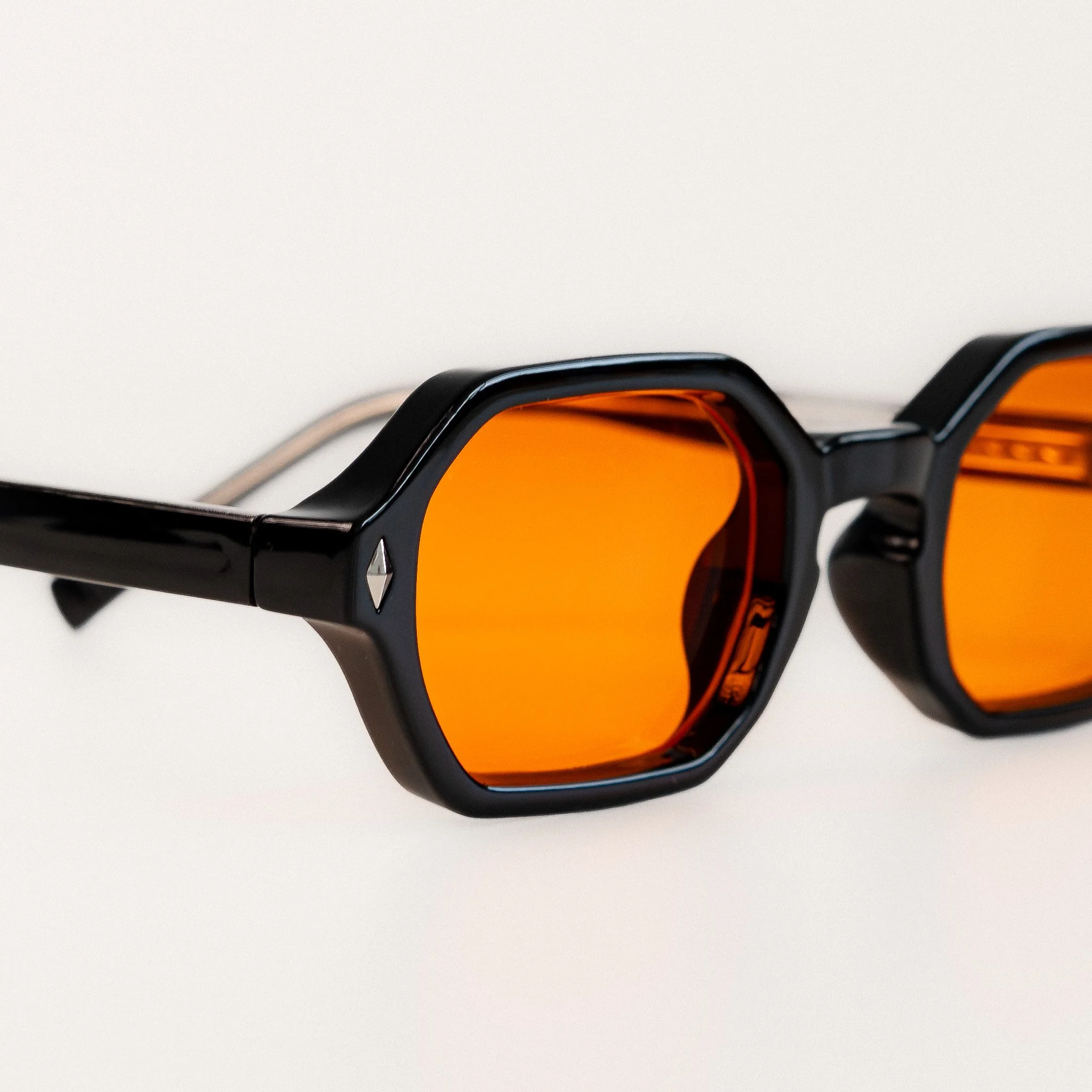 Soho blue light glasses side view close up black acetate hexagonal frame with amber orange lenses