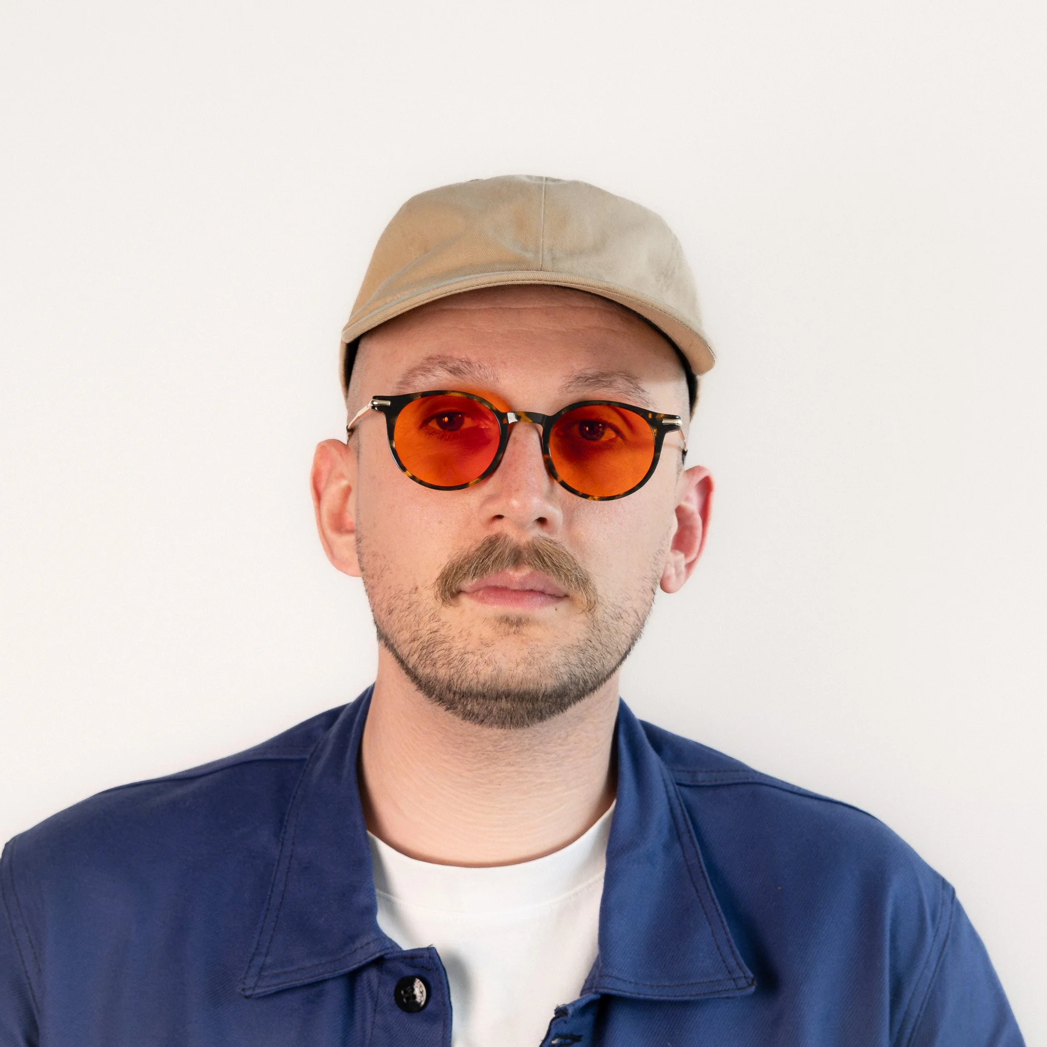 Alden blue light glasses worn front view tortoise acetate round frame with amber orange lenses