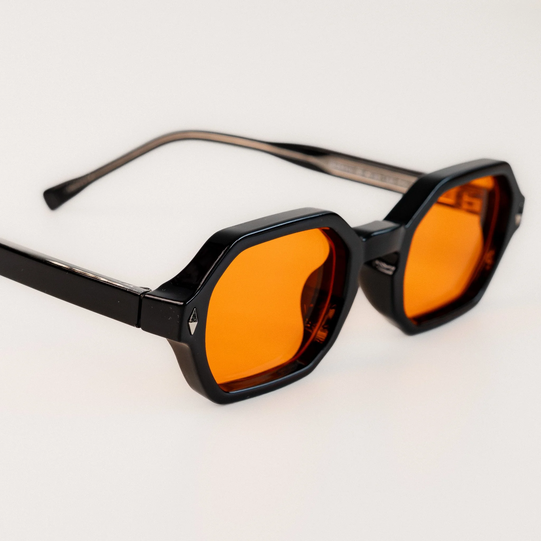 Soho blue light glasses front view close up black acetate hexagonal frame with amber orange lenses