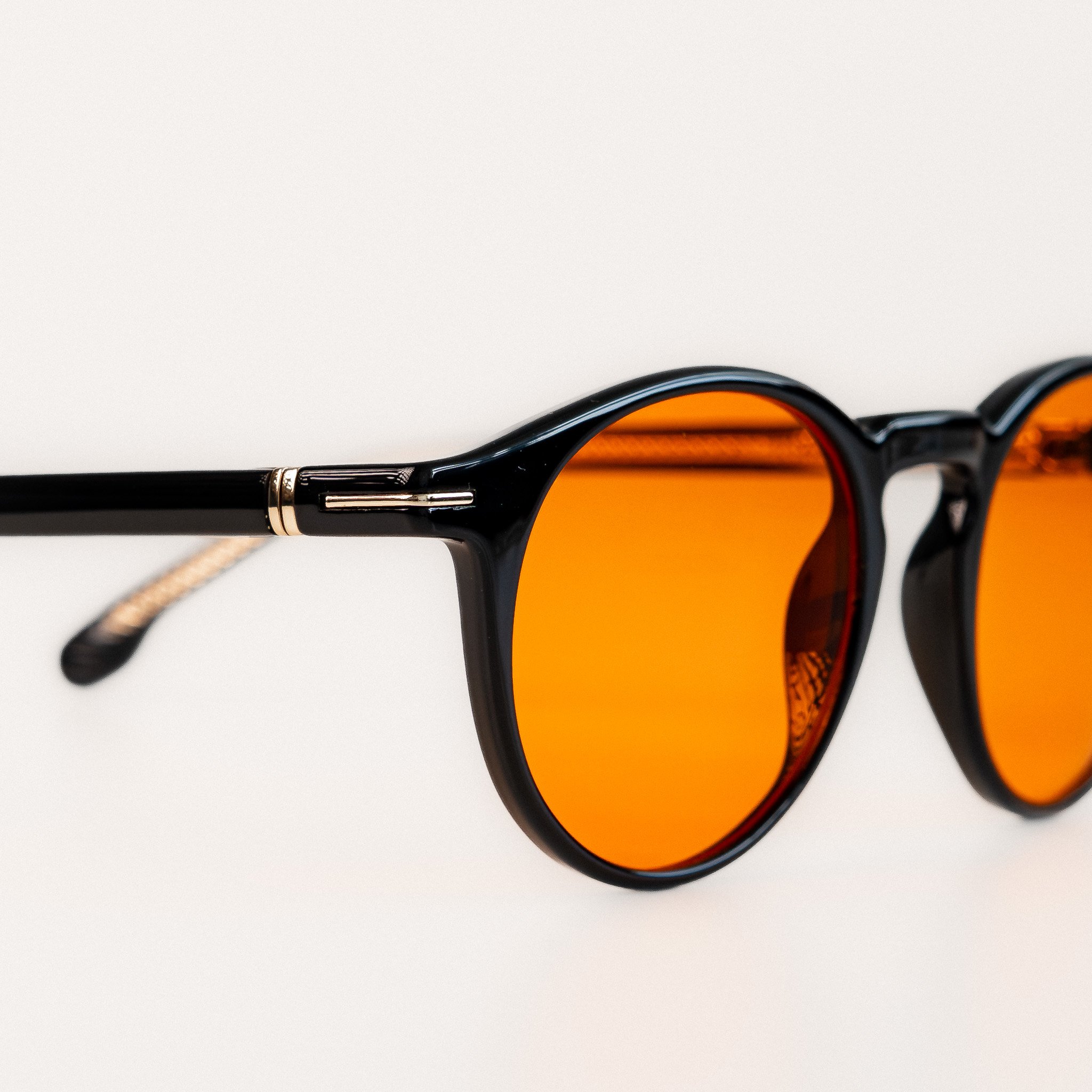 Durham blue light glasses close up front view black acetate round frame with amber orange lenses