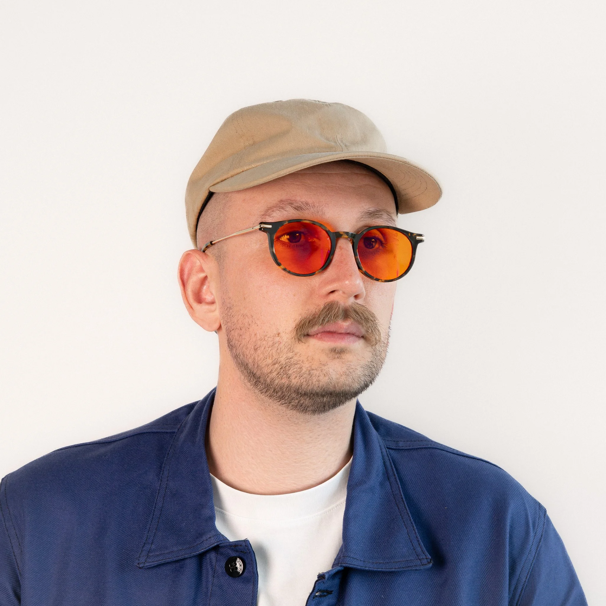 Alden blue light glasses worn side view tortoise acetate round frame with amber orange lenses