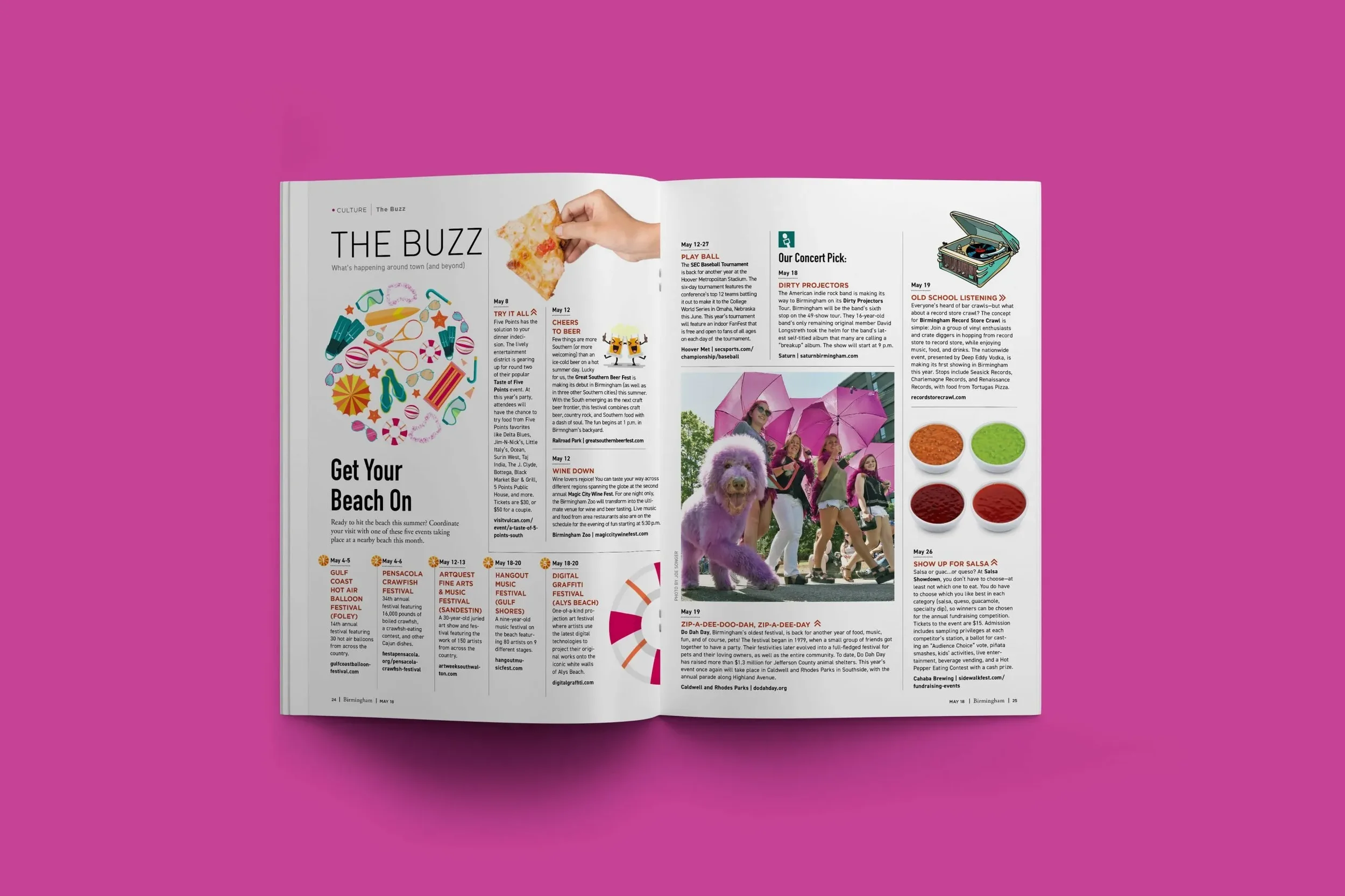 Open magazine resting on a pink background, displaying articles about local events, a photo of women holding pink umbrellas and a purple dog, and colorful event advertisements.