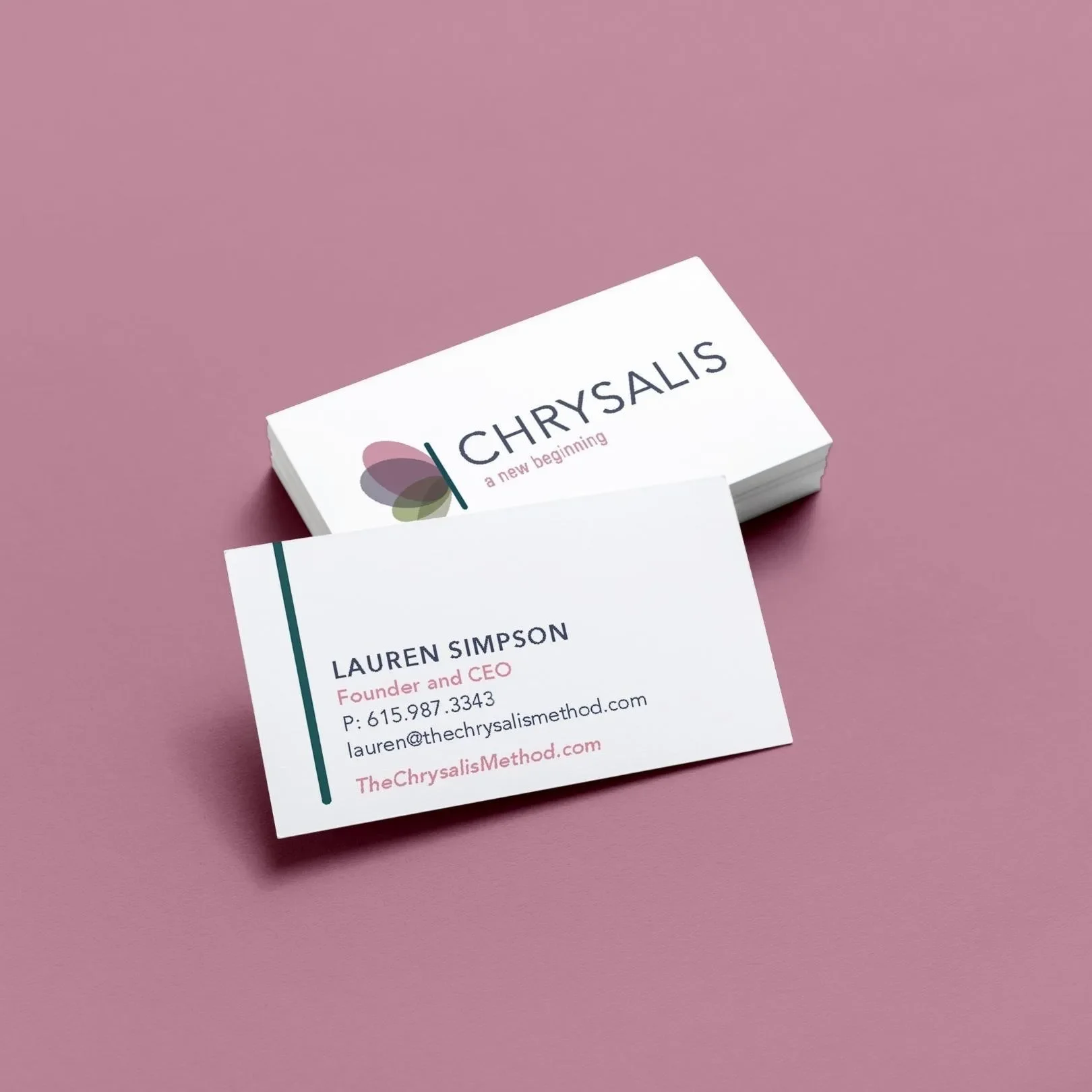 Business cards for Lauren Simpson and Chrysalis Method placed on pink background.