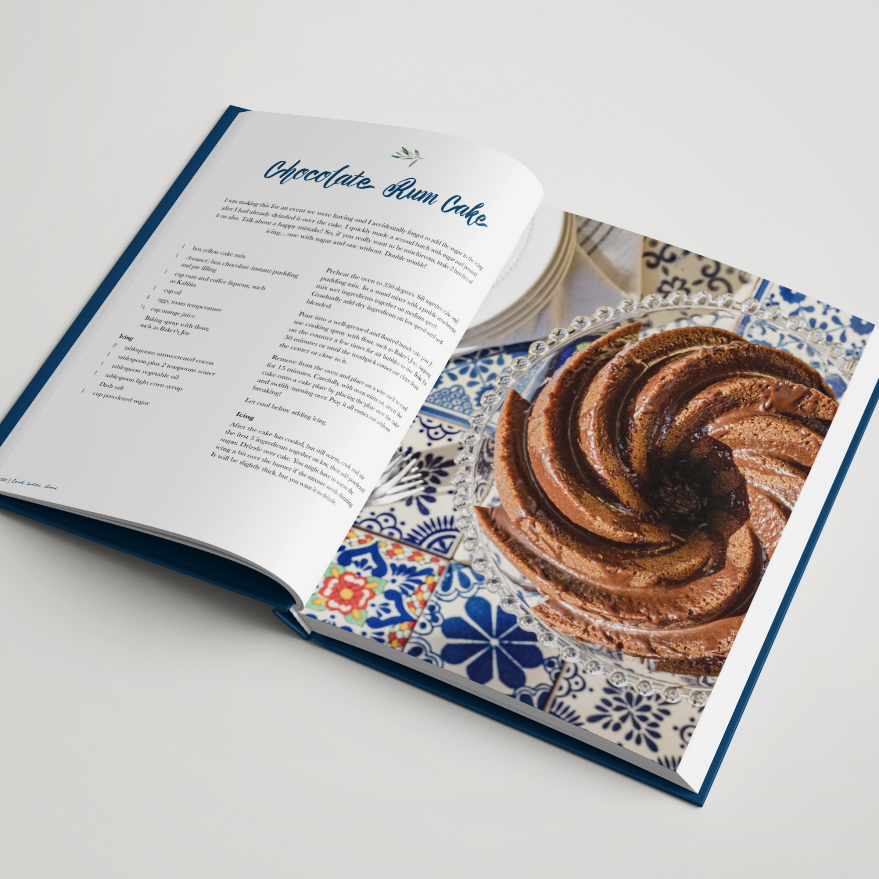 Open cookbook displaying a chocolate rum cake recipe and a photo of a chocolate swirl bundt cake on a decorative plate.