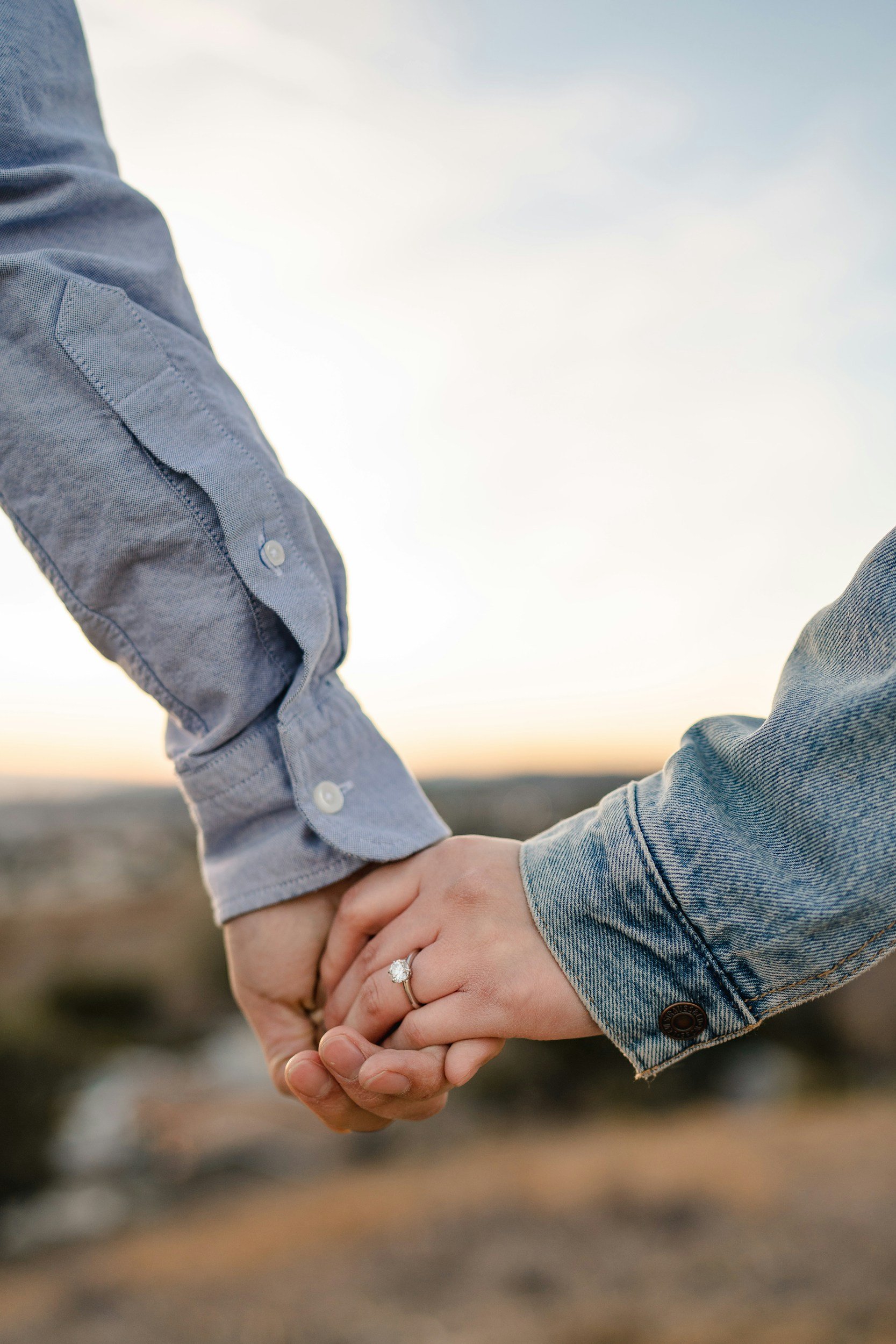 couple holding hands at sunset