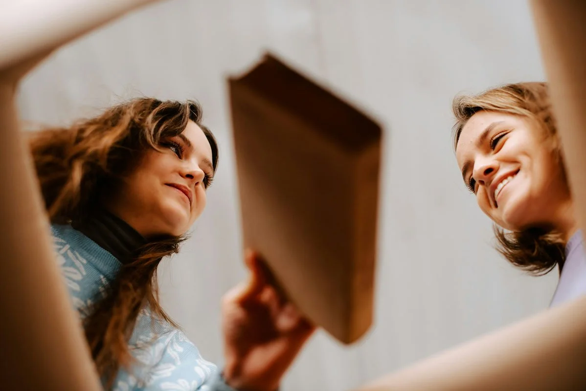 lesbian couple at home unpacking boxes together