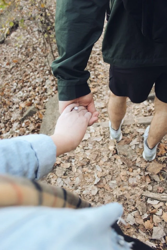 couple holding hands on a hike