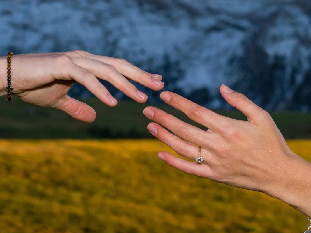 two hands reaching for one another