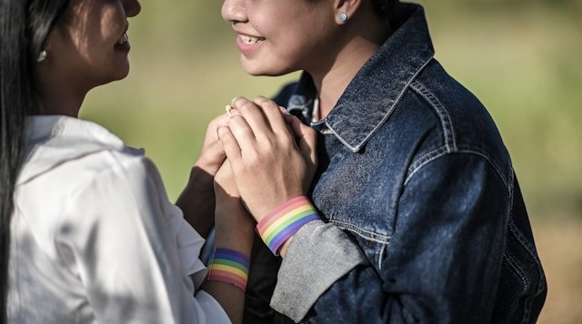 same-sex couple smiling lovingly at each other