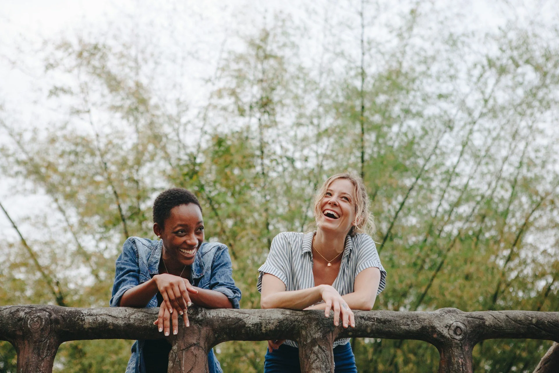 lesbian couple laughing together on a hike