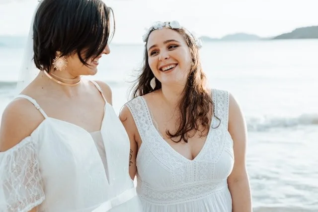lesbian couple smiling at their wedding