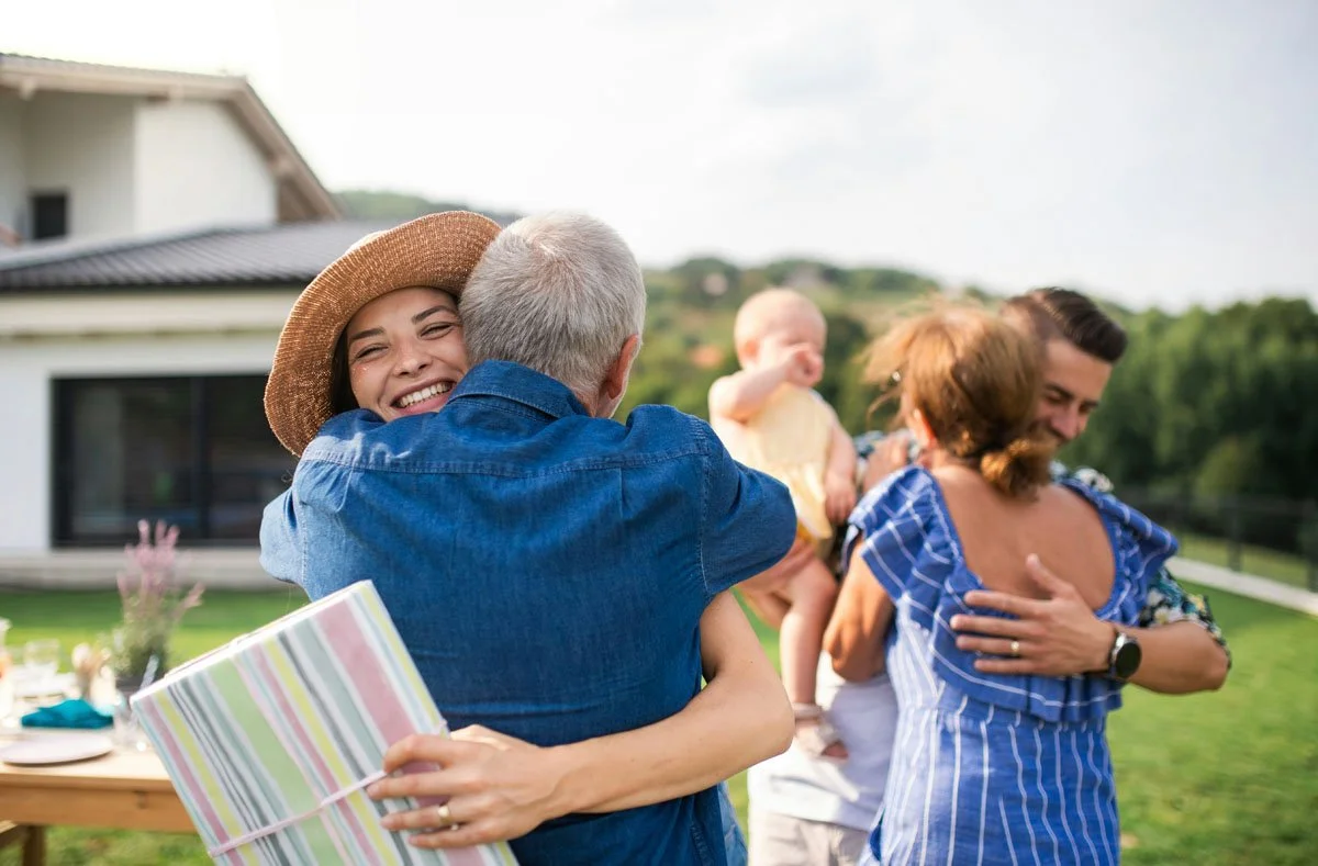 Family members embracing one another in an outdoor setting