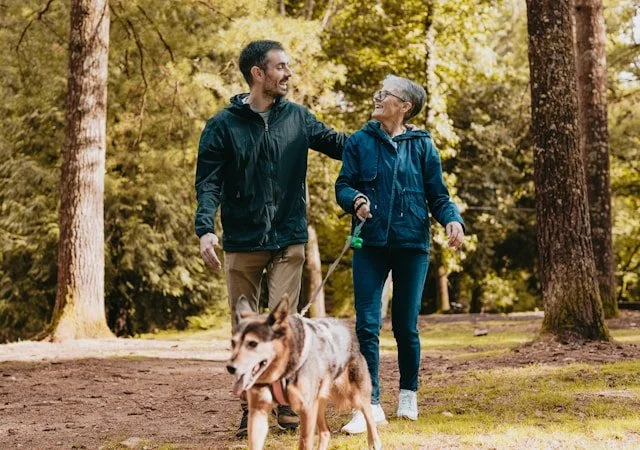 mother and her adult son walking the dog together