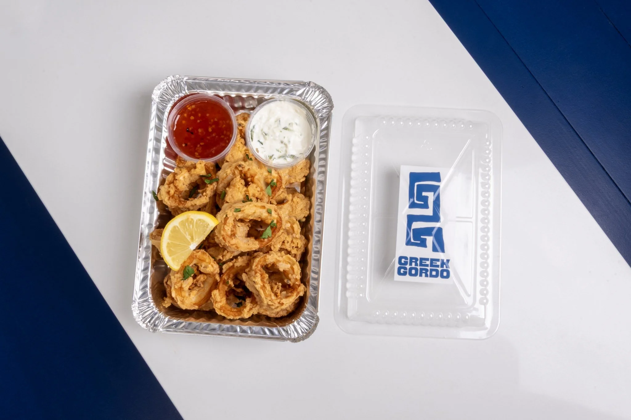 Greek Gordo's fried calamari with lemon wedges, and two dipping sauces