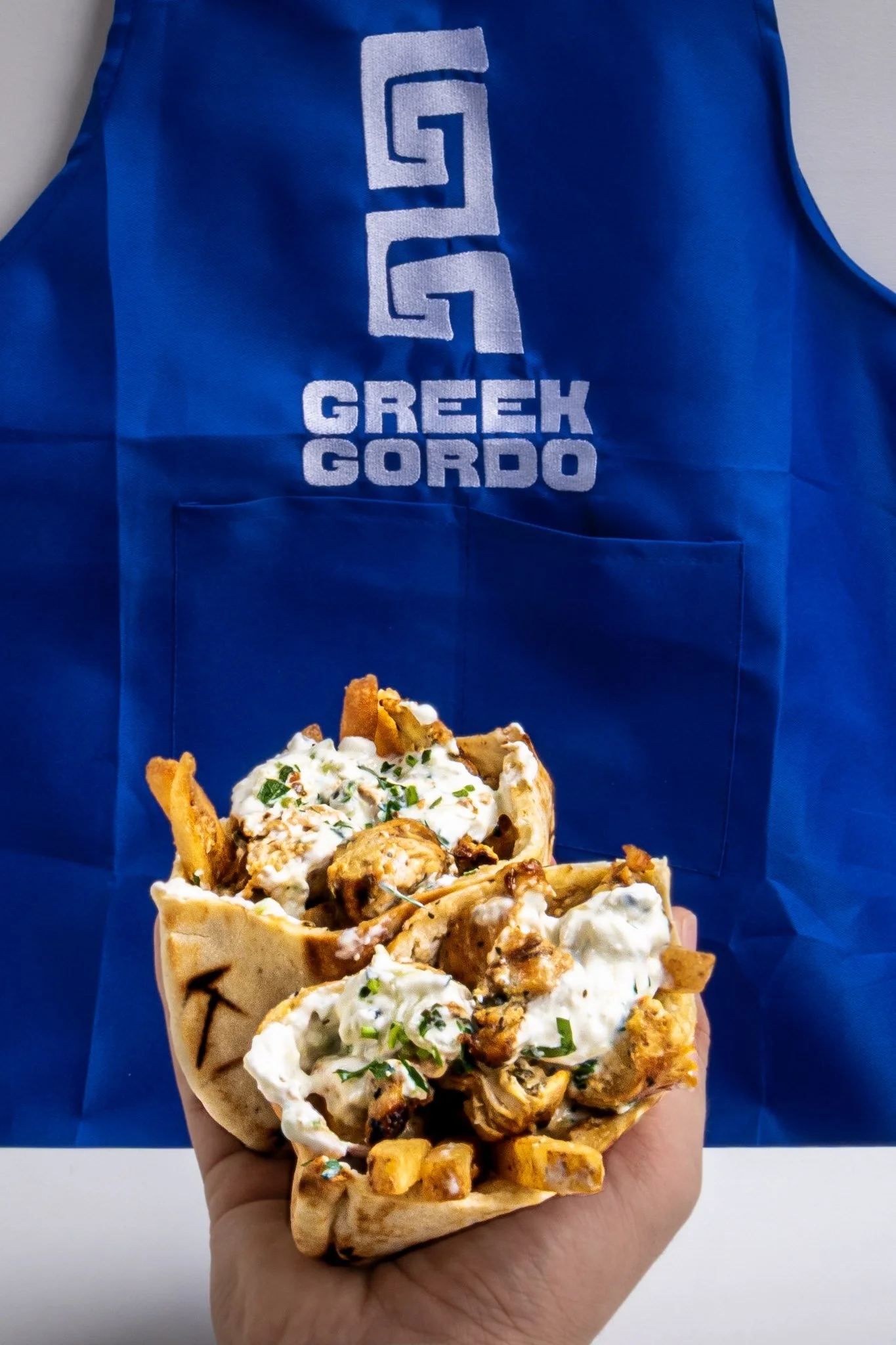 Toronto Best Greek gyro with grilled meat, white sauce, and chopped herbs Greek Gordo