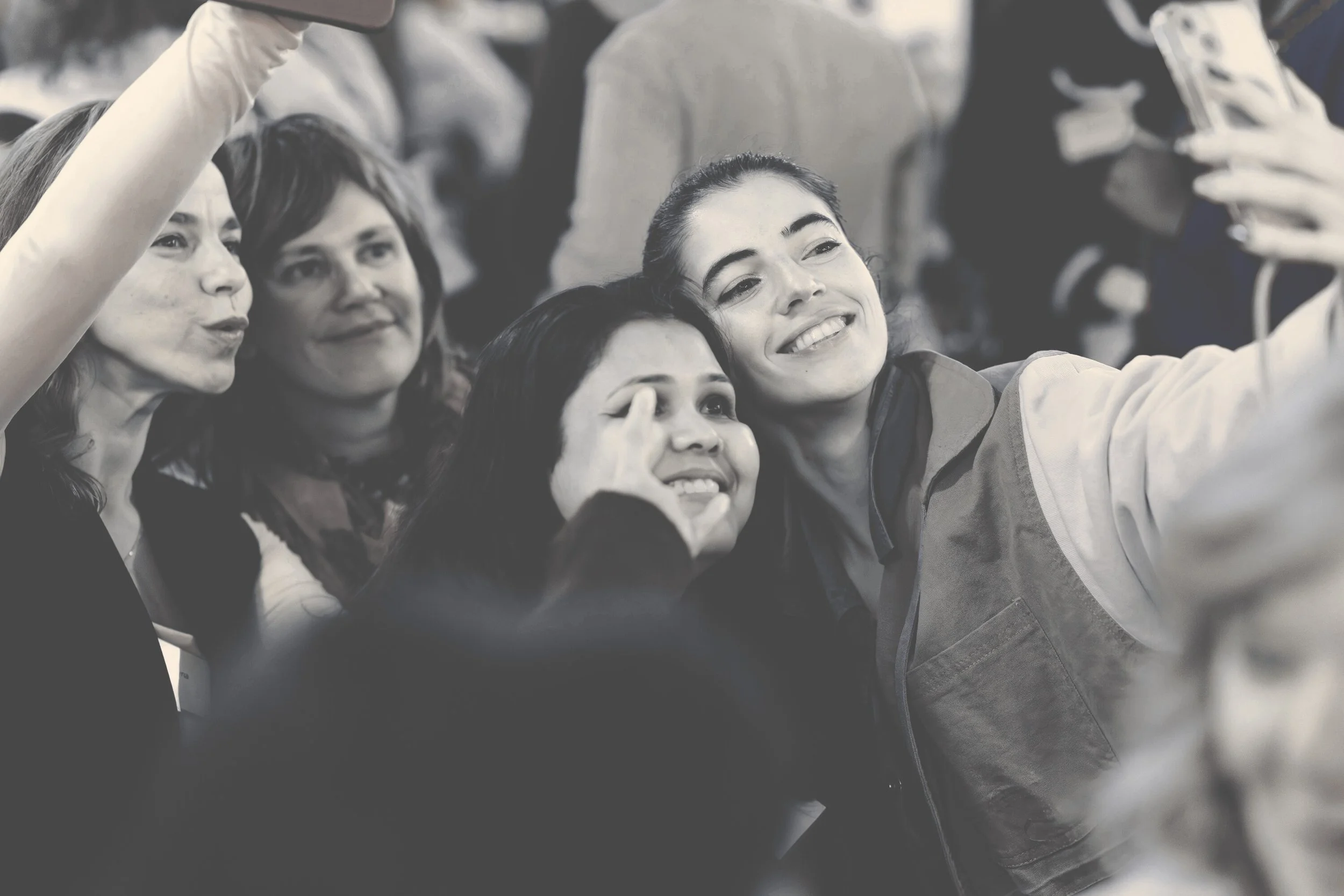 Group of women taking a selfie together at an event.