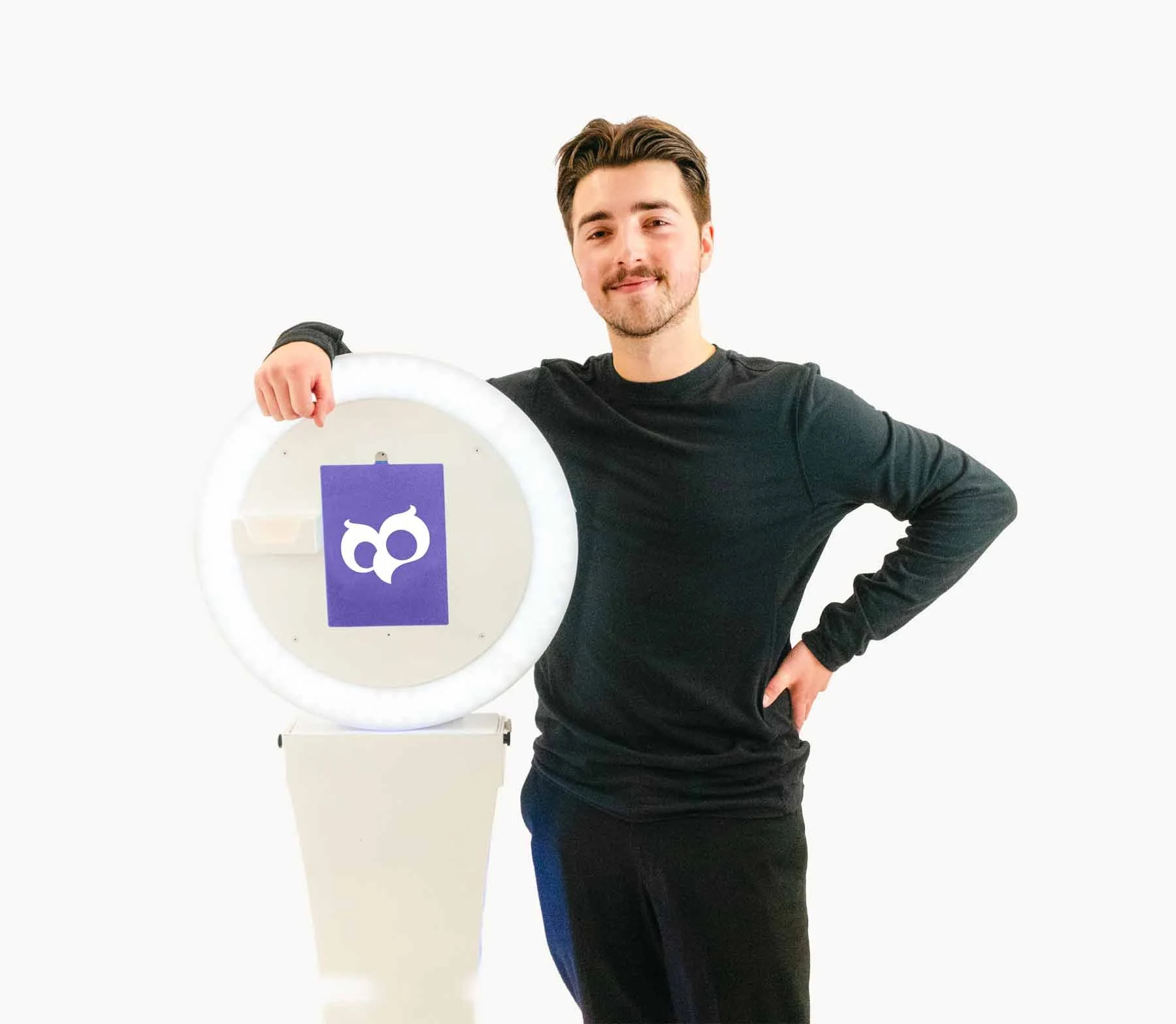 Photo Hoot owner standing beside photo booth in the Greater Edmonton Area