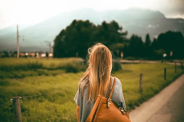 woman looking at trees facing away