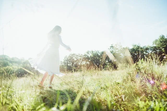 woman in field in the sun