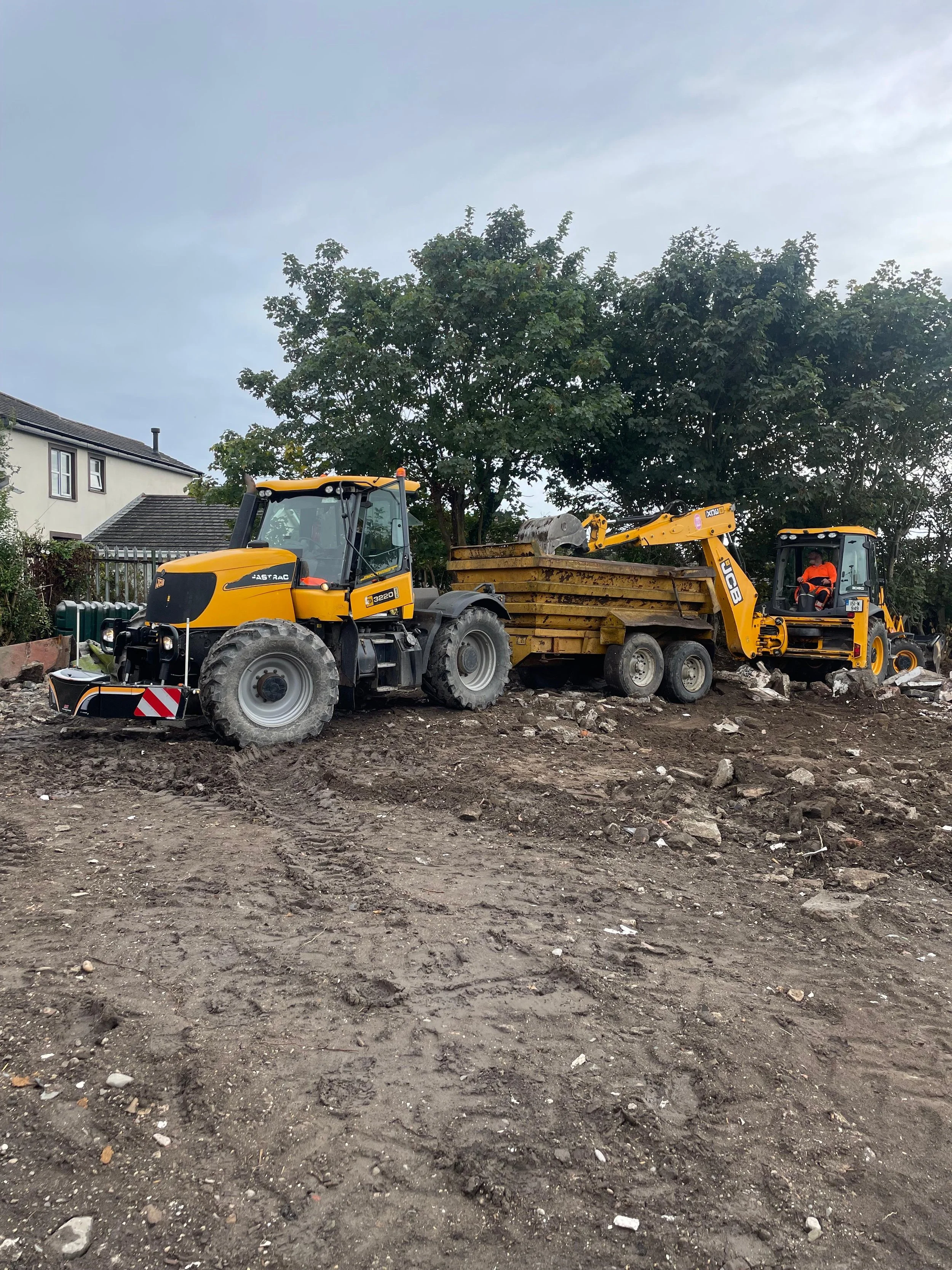 Construction site with two yellow loaders moving earth and rocks