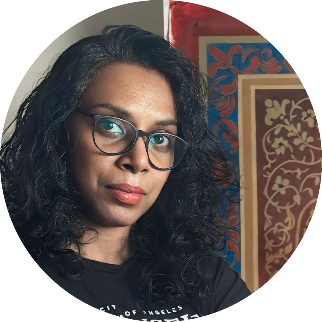 Portrait of Sunitha Gopal, contemporary realist artist and founder of SUNARTCAFE, with artwork in the background.