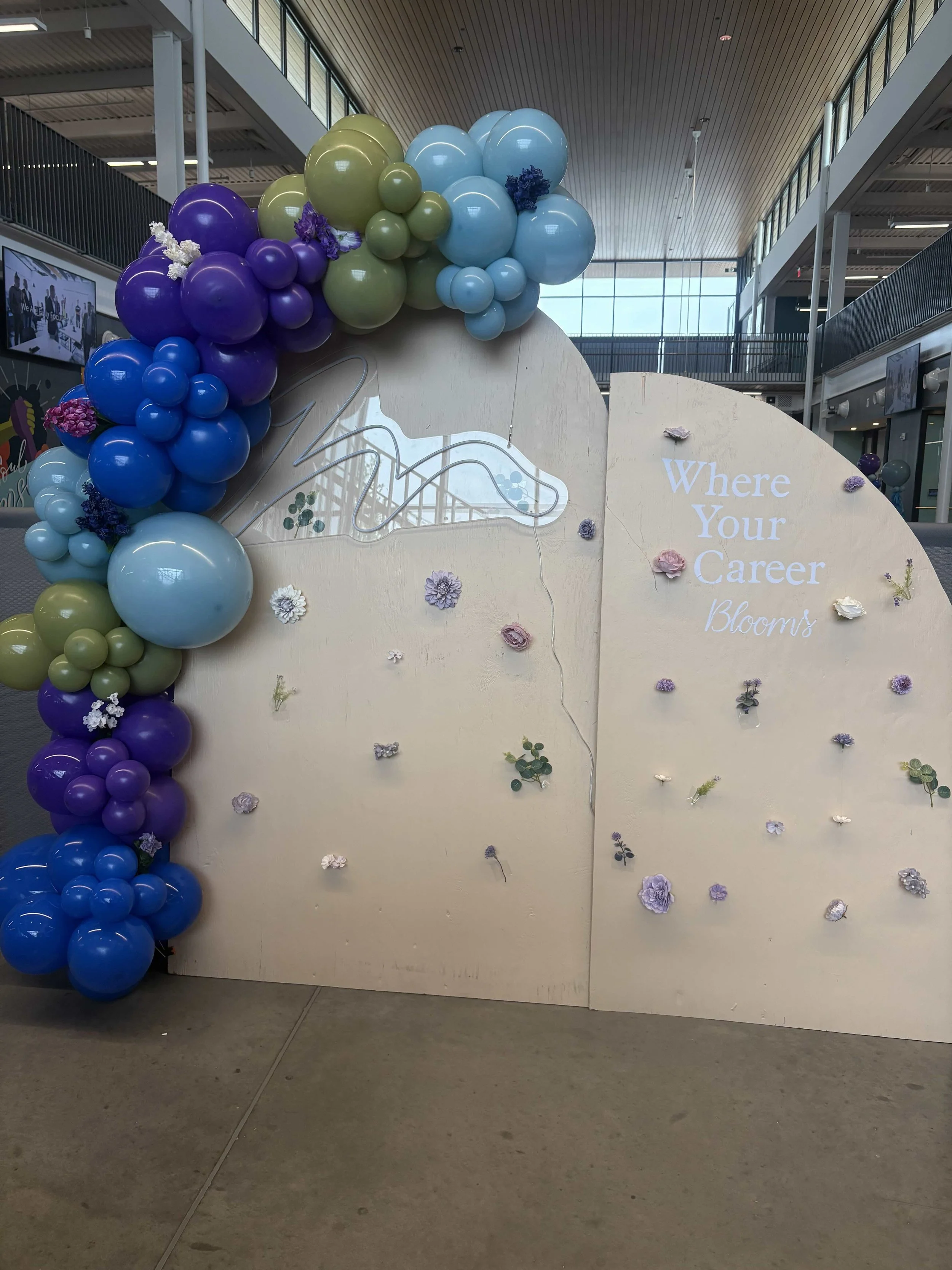 Decorative display with multicolored balloons and flowers, and the phrase "Where Your Career Blooms" written on the right side.