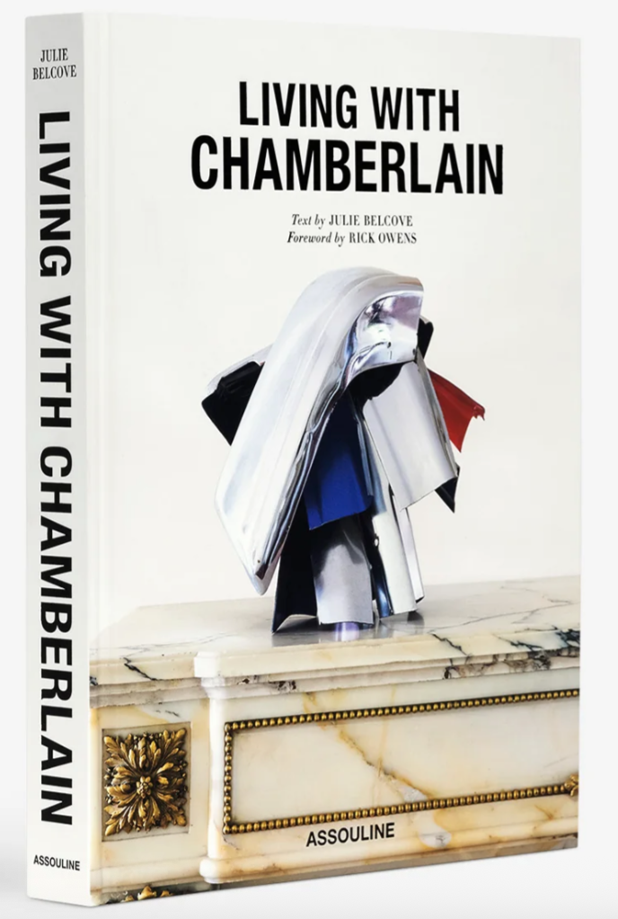 Book titled 'Living with Chamberlain' by Julie Belcove, with a foreword by Rick Owens, featuring an abstract sculpture made of colorful metal, placed on a marble surface with gold details.