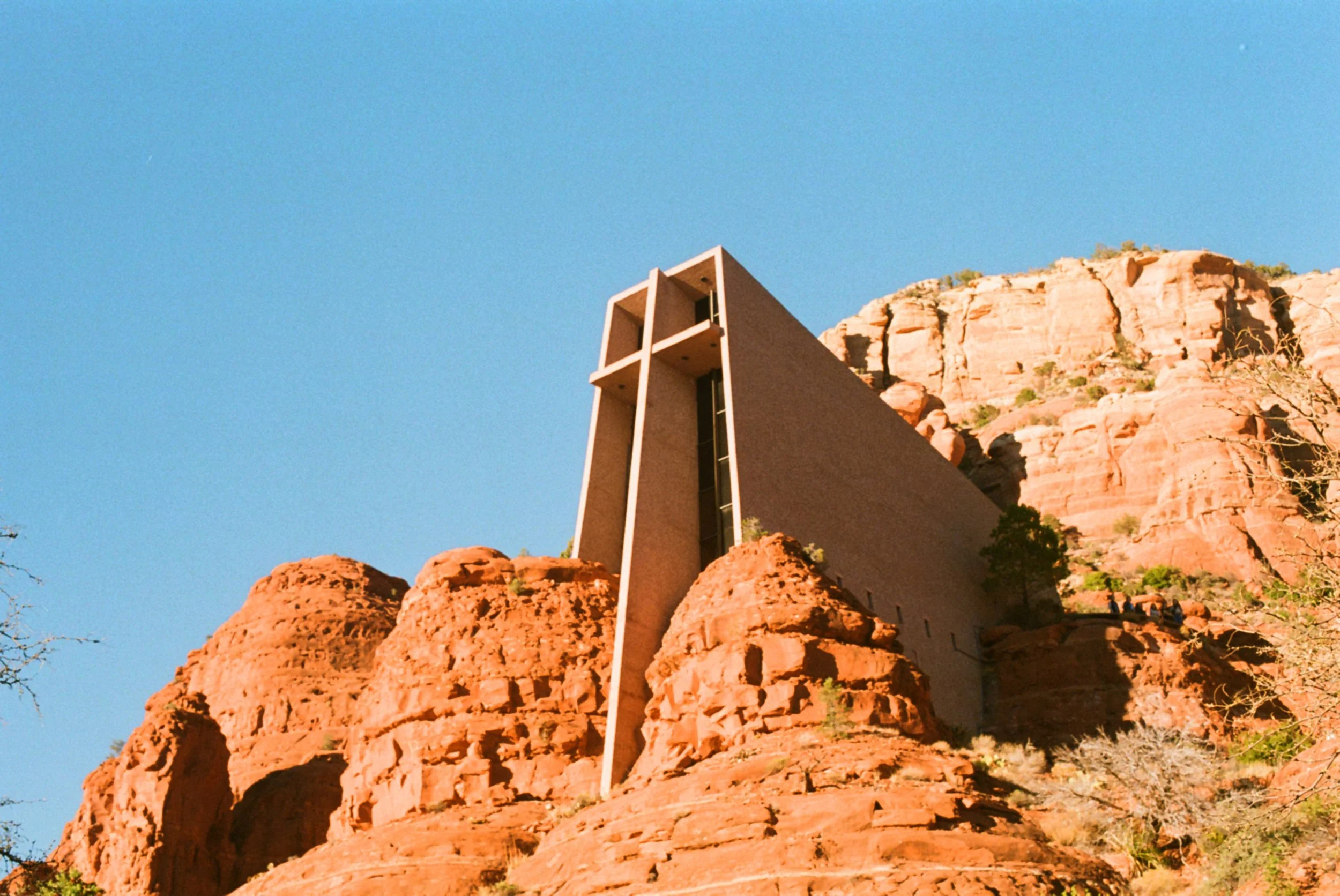 The Signature Houses in Sedona, Arizona, nestled among red rock formations under a clear blue sky.