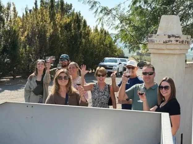 group of people with wine at crush pad on estate tour