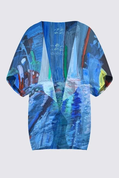 A short-sleeve shirt with an abstract painting of a cityscape in shades of blue, green, and red.