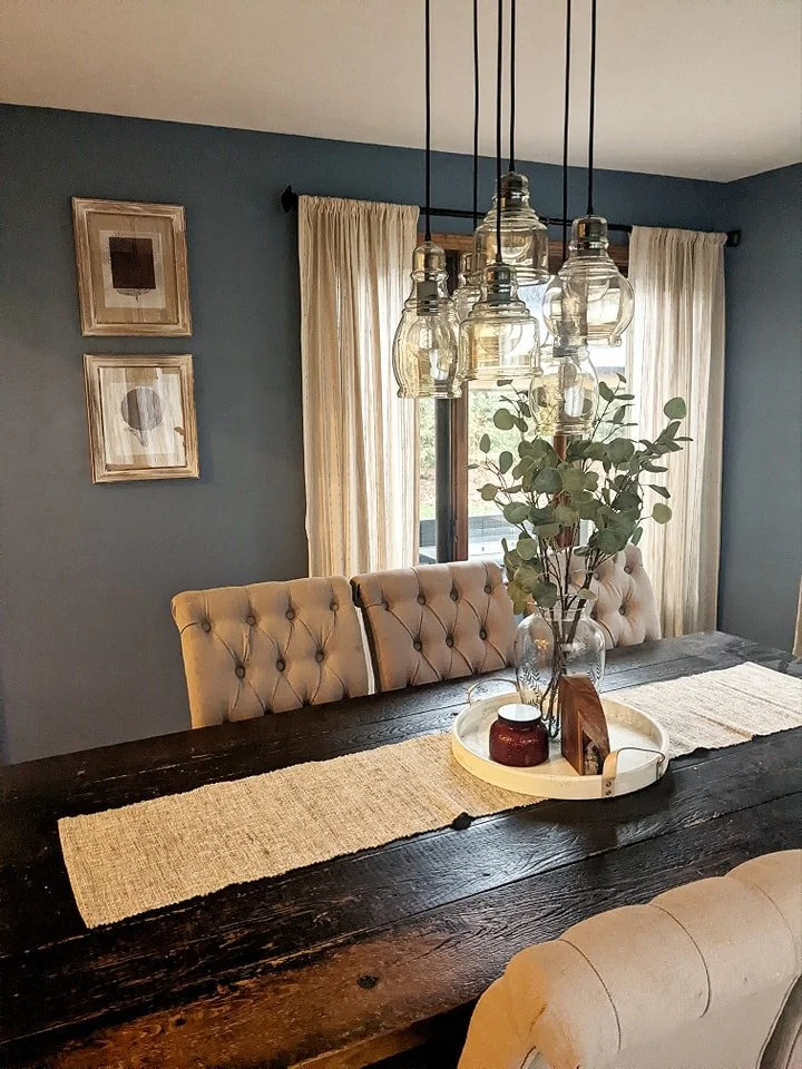 Photo of a cozy, blue farmhouse chic modern dining room by Revival Interior Design.