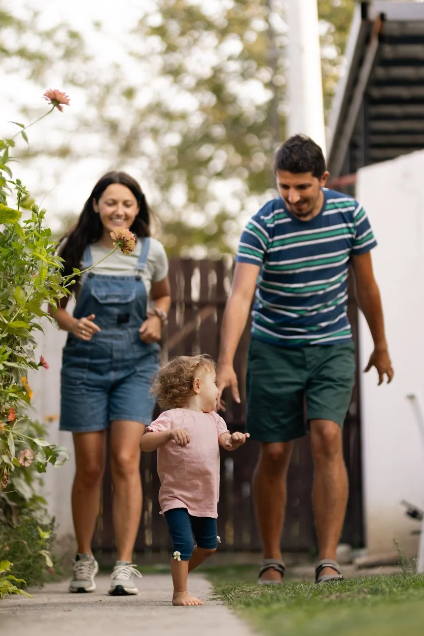 Family of three walking together in their backyard, representing the courage it takes to reach out for help.