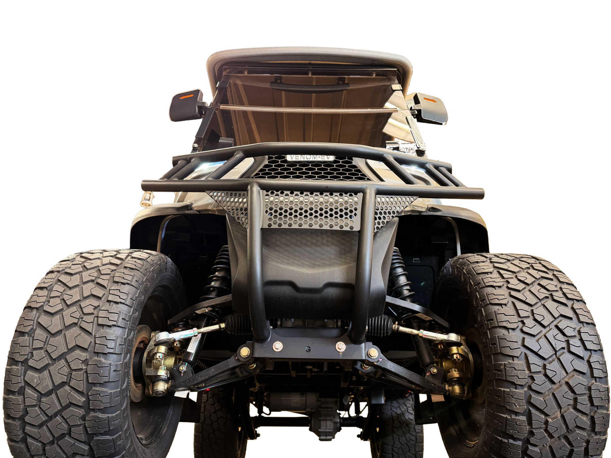 View of the front of an off-road vehicle with large rugged tires, a metal bumper, suspension system, and a windshield, showing the vehicle's underbody and front components.