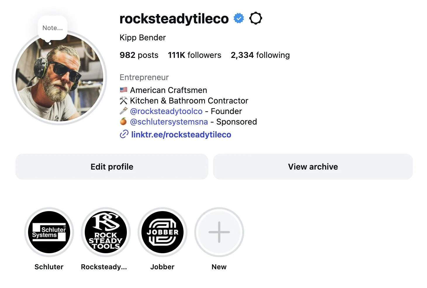 Instagram profile page of rocksteadytileco, featuring a profile picture of a man with sunglasses and headphones, with follower and post statistics, and logo icons of Schluter Systems, Rocksteady Tools, and Jobber.