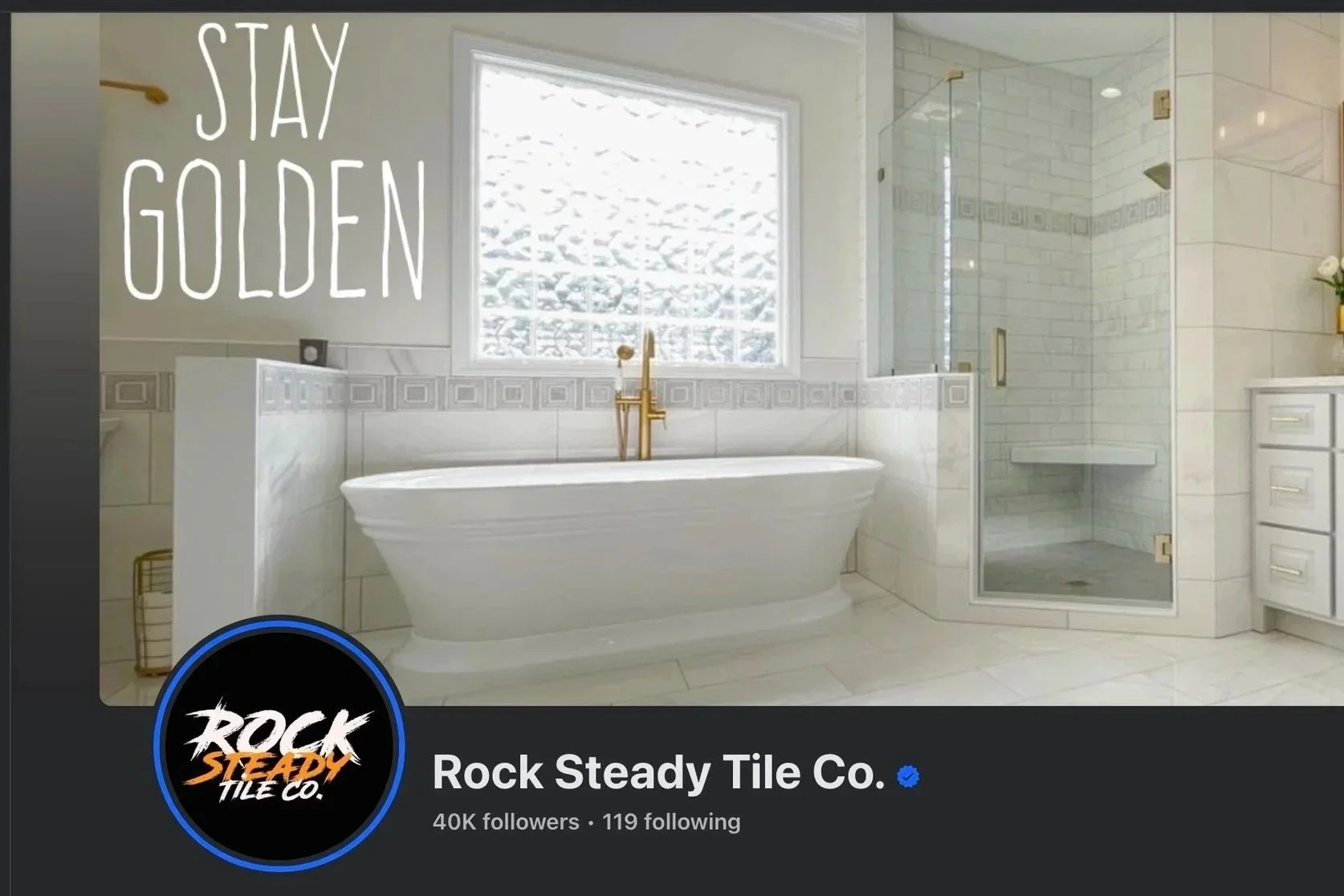 Modern bathroom with a white bathtub, a glass-enclosed shower, a window with snow outside, and a white cabinet. Text on the image says 'Stay Golden'.